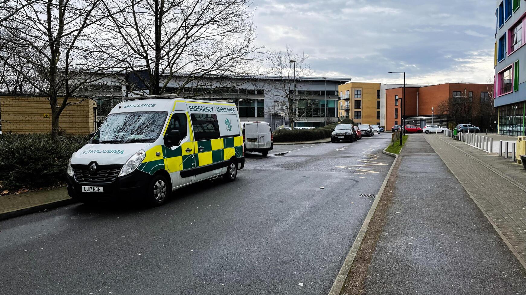 London, UK - March 02, 2025- Ambulance parked on a road near modern buildings in Enfield, London, UK photo