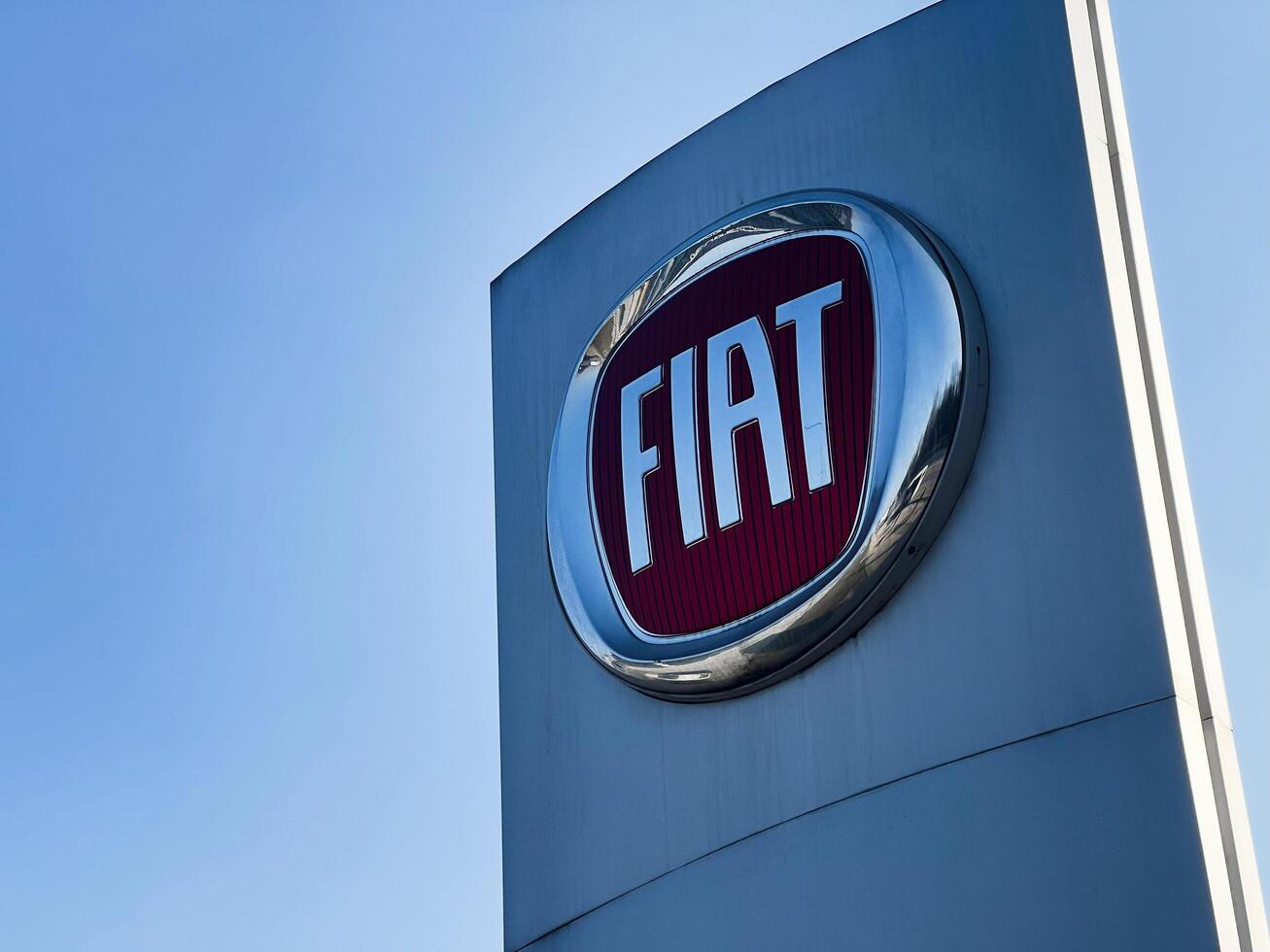 Kyiv, Ukraine - March 04, 2025- Fiat logo on a tall signage against a clear blue sky background photo