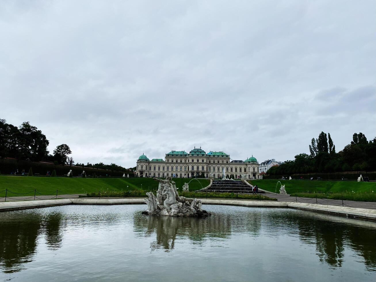 Vienna, Austria - March 10, 2024-Beautiful symmetrical view of Belvedere Palace gardens in Vienna under a cloudy sky photo