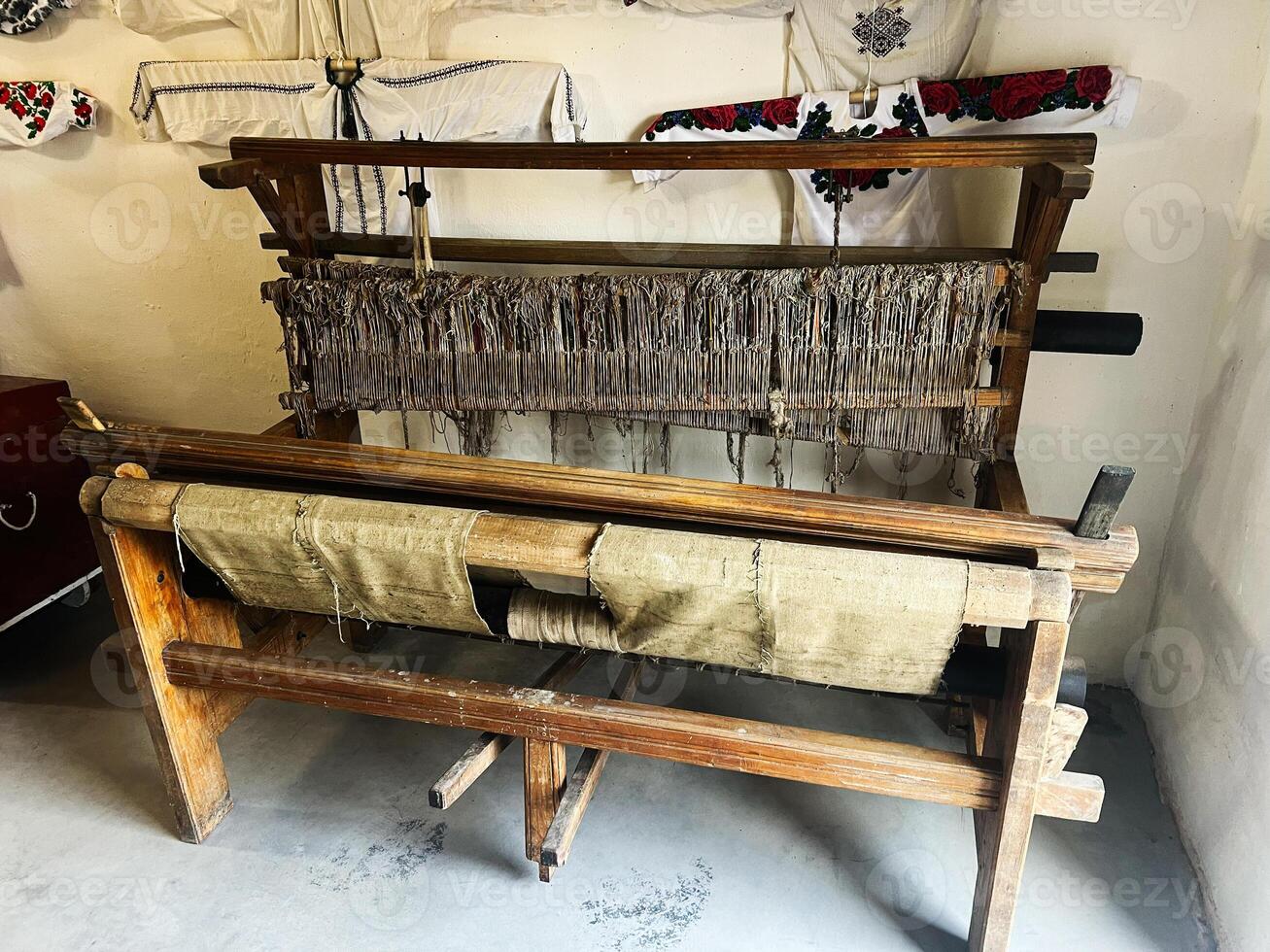 Traditional wooden loom with fabric in a rustic setting showcasing cultural heritage photo