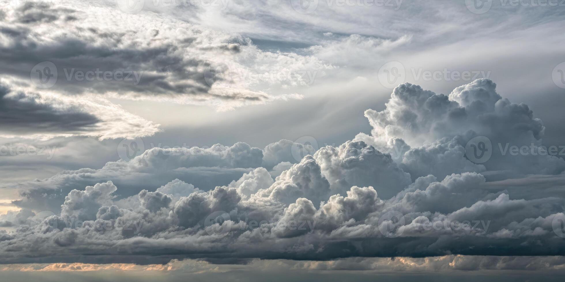 The sky filled with stunning cumulus clouds creates a dramatic scene of nature's beauty after a storm. photo