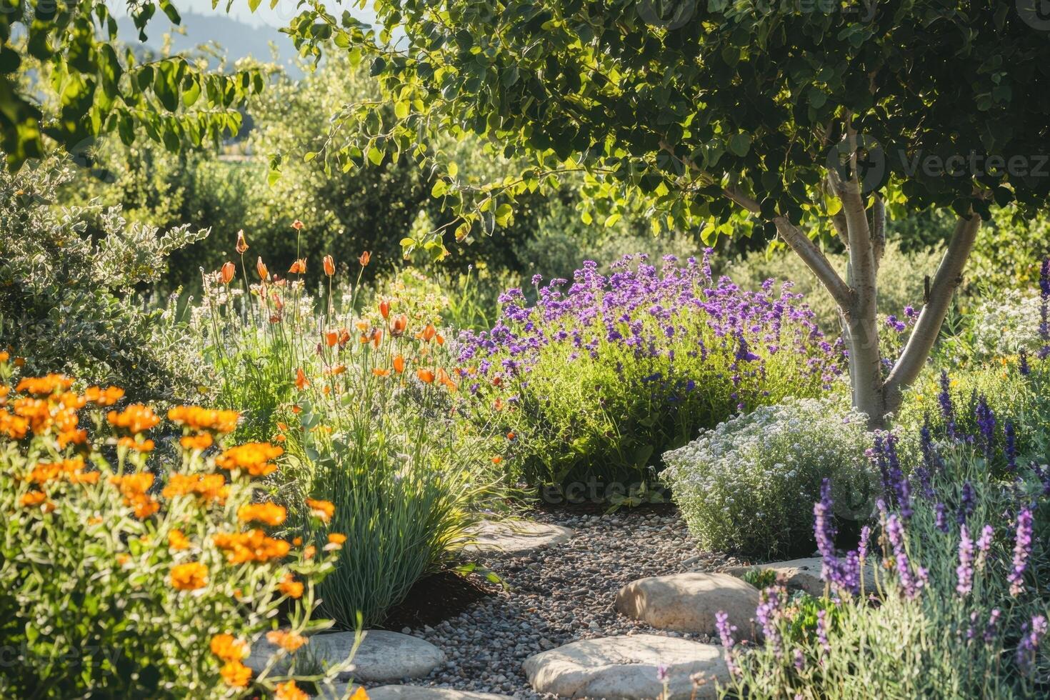 A garden with a path lined with flowers and a tree photo