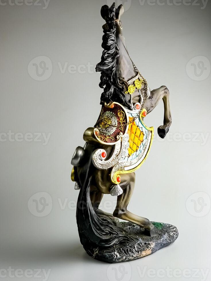 Statuette of a horse in harness. Horse is rearing. photo