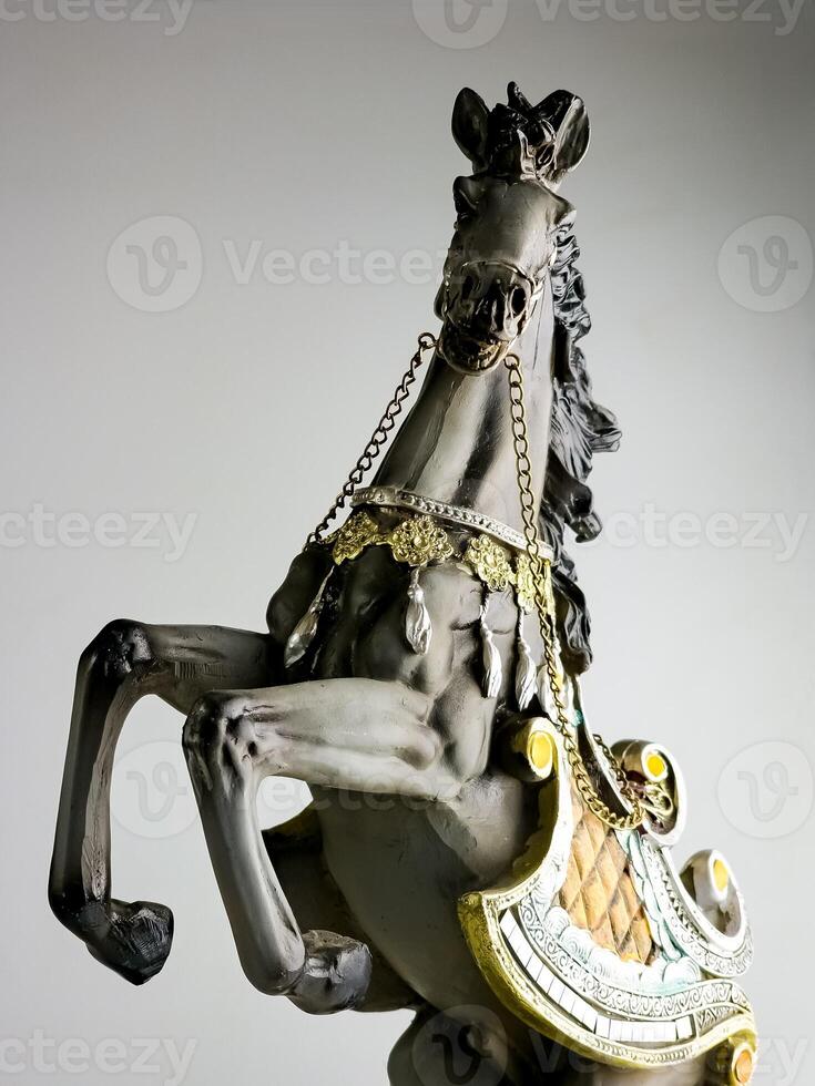 Statuette of a horse in multi-colored harness. Horse is rearing. photo