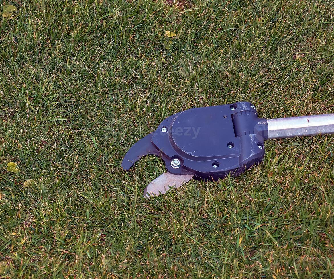 Pruning shears for high-altitude work. Close-up photo
