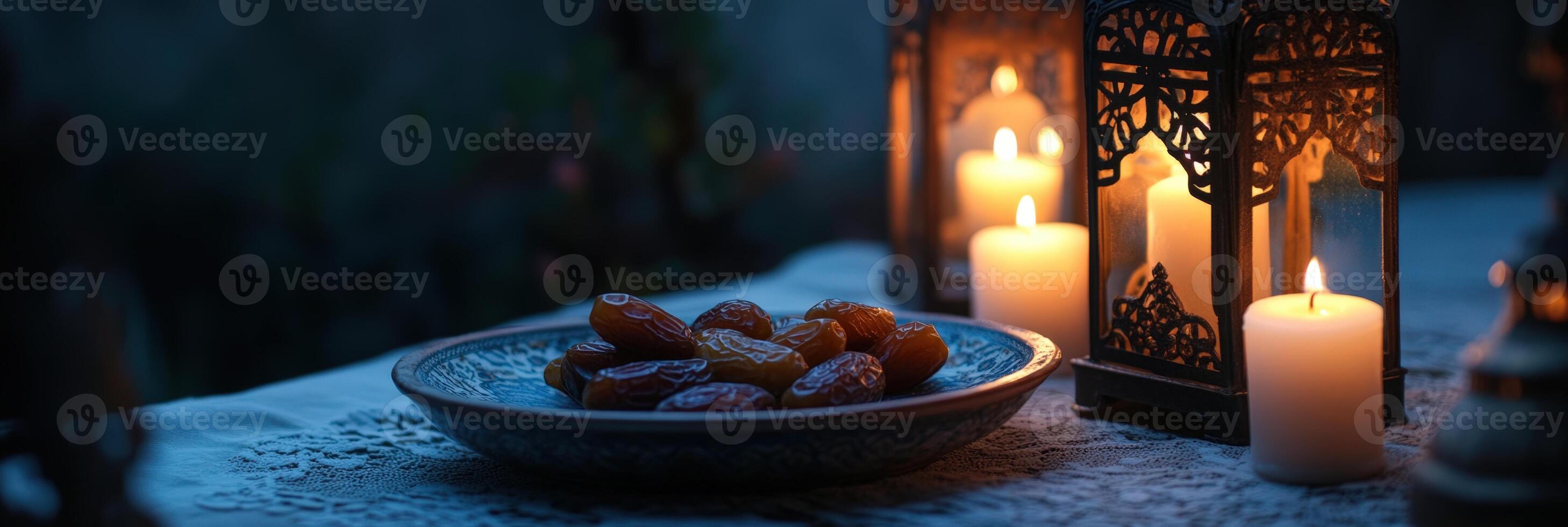Candles and dates in a bowl on a table photo