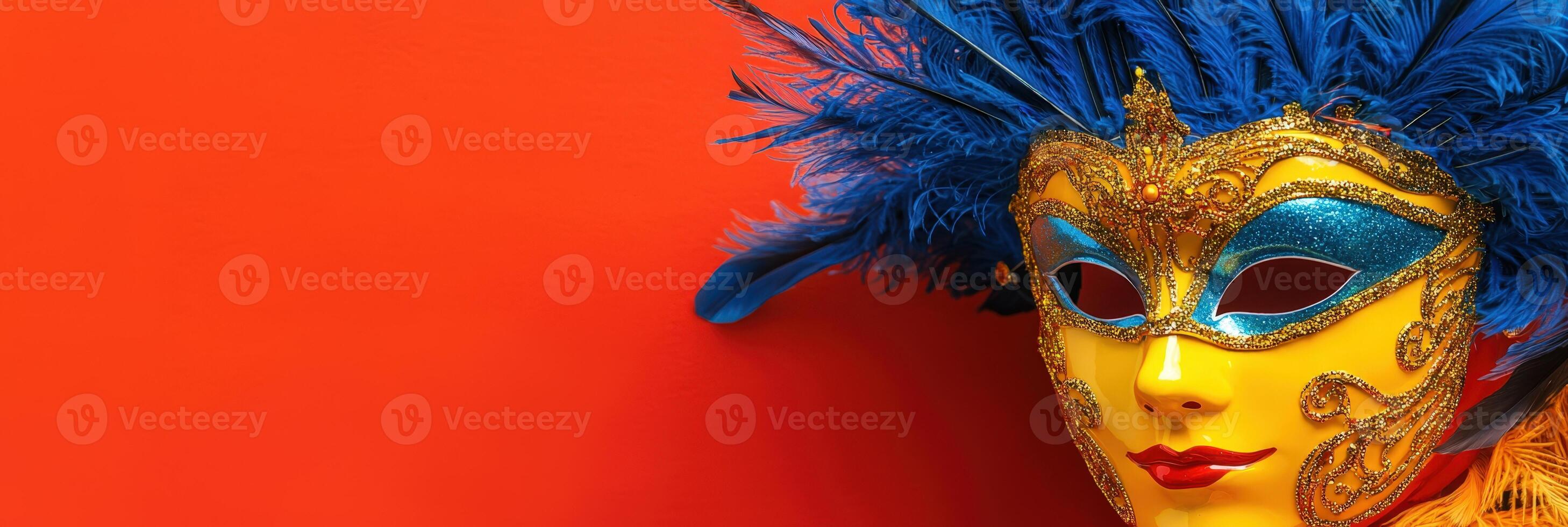 A colorful carnival mask with blue feathers on an orange background photo