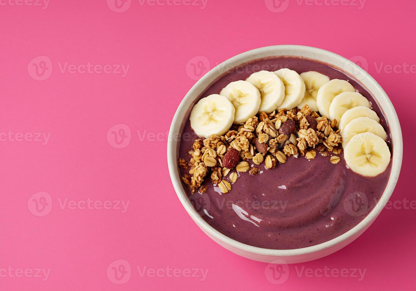 Acai Bowl with Granola Topping and Banana Slices photo