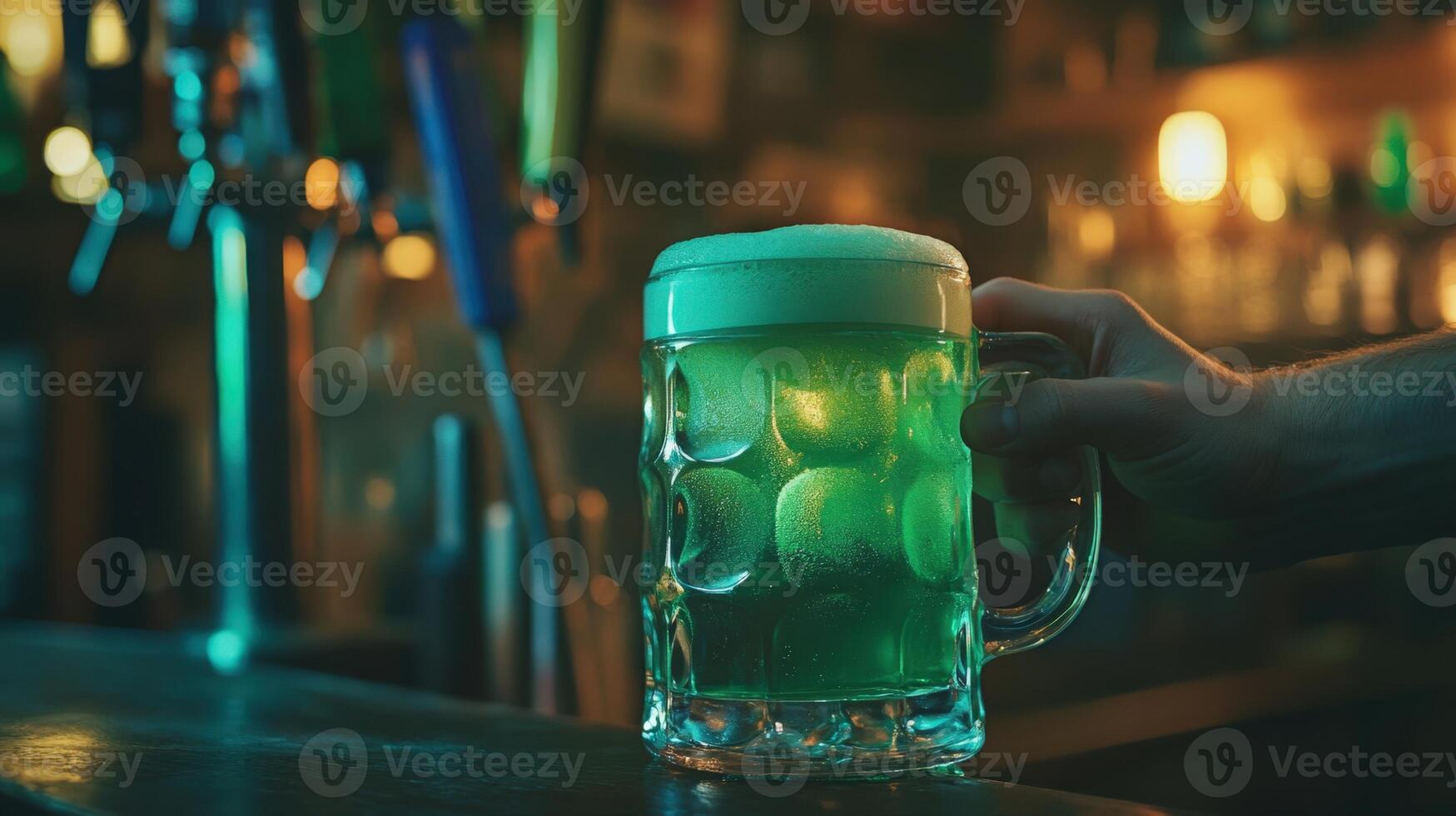 A person holding a beer mug with green liquid photo