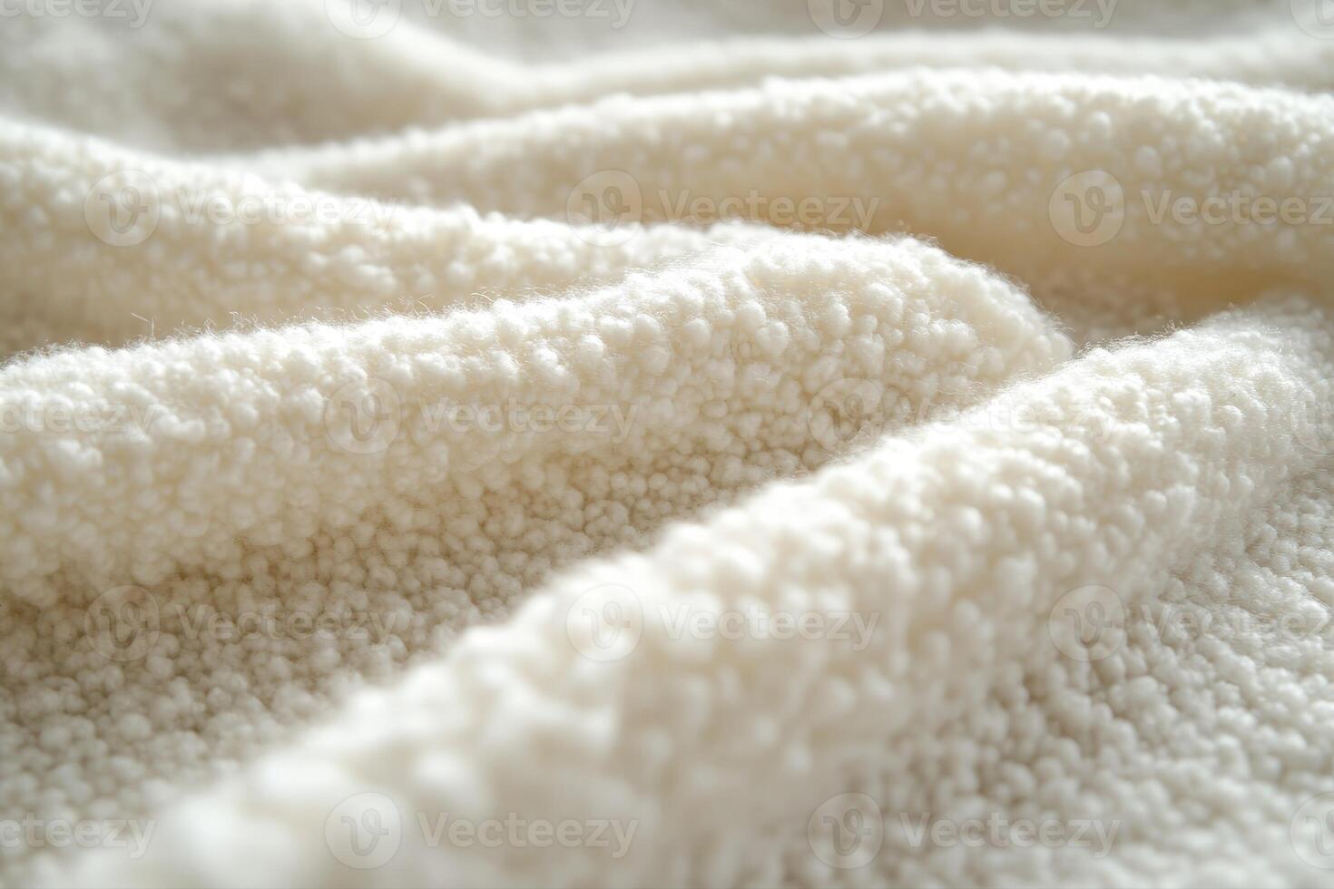 Soft white boucle fabric displaying textured folds and warmth photo