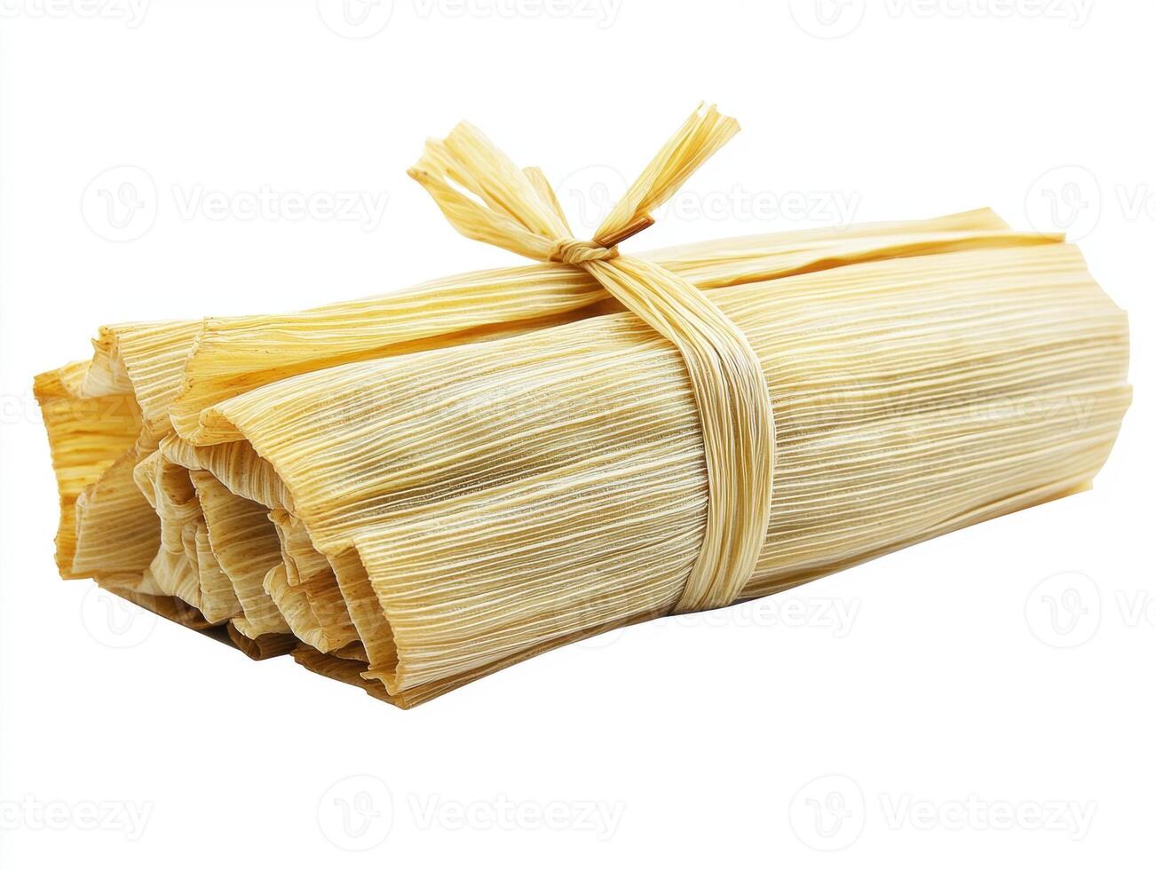 Freshly prepared tamales wrapped in corn husks ready for cooking photo