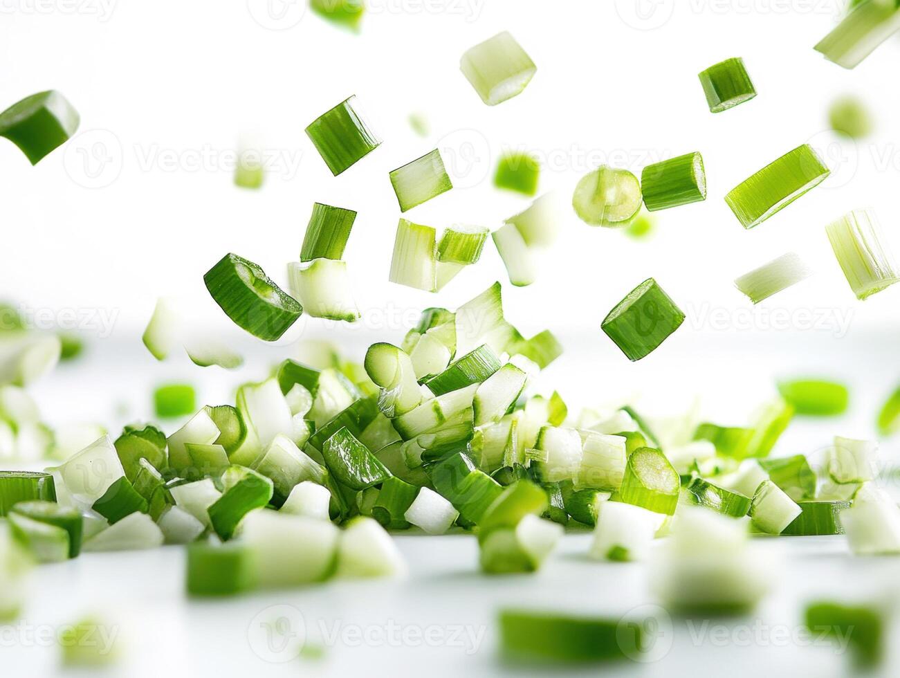 Chopped green onions falling in the kitchen during preparation photo