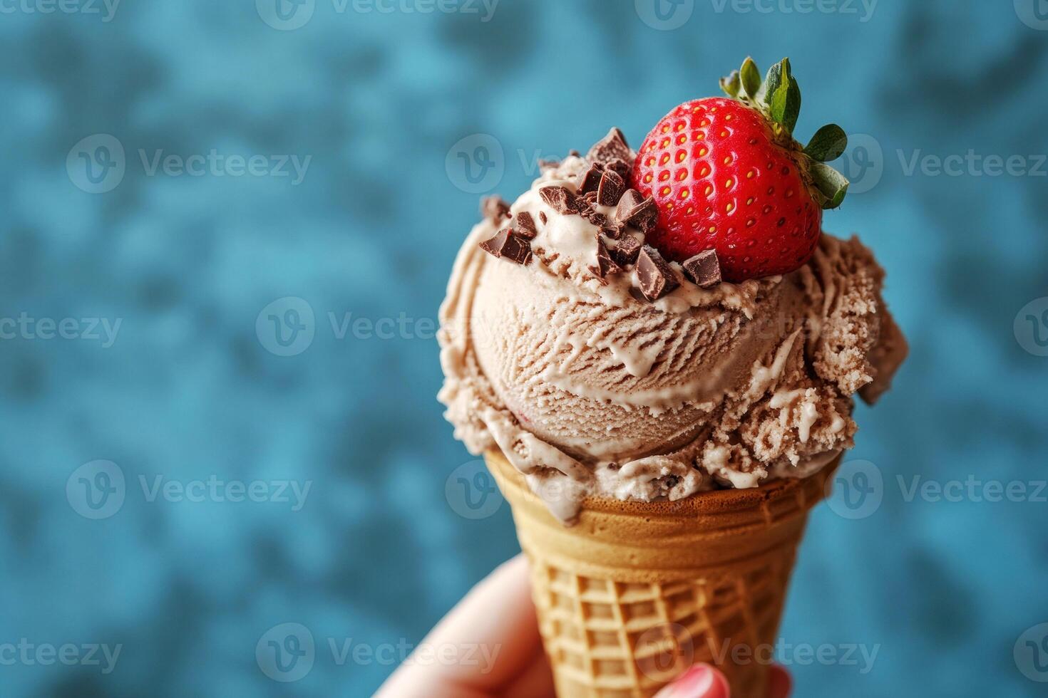 Delicious ice cream cone with chocolate and strawberry topping photo