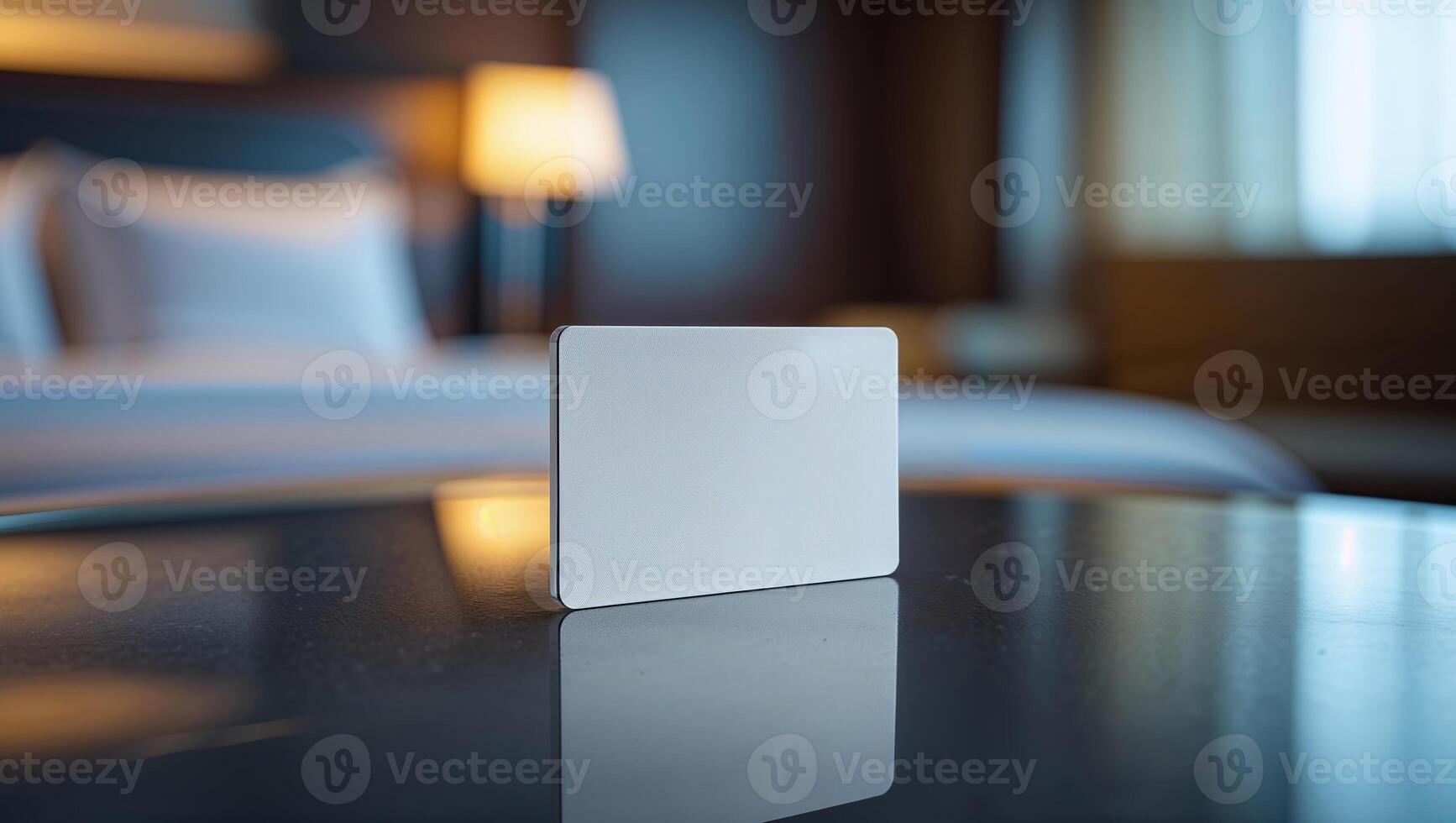 Blank card placed on a table in a modern hotel room at night, highlighting the cozy atmosphere and elegant interior design photo