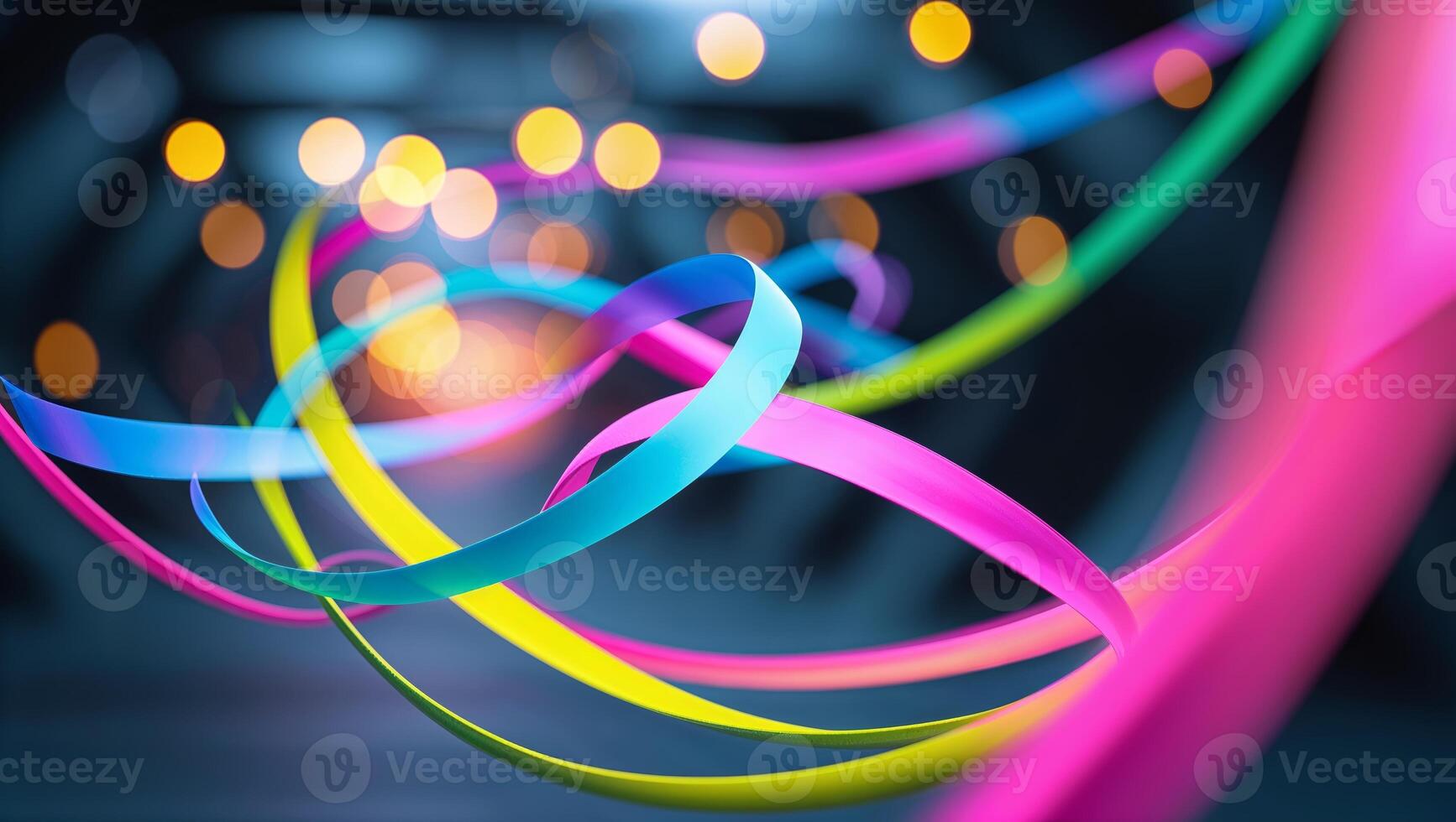 Colorful ribbons swirl in a dark space illuminated by bright lights during a vibrant event at night photo