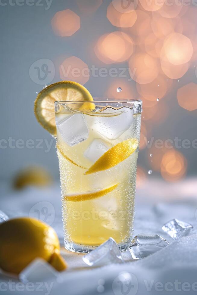 Refreshing lemon drink with ice and lemon slices against a blurred background photo