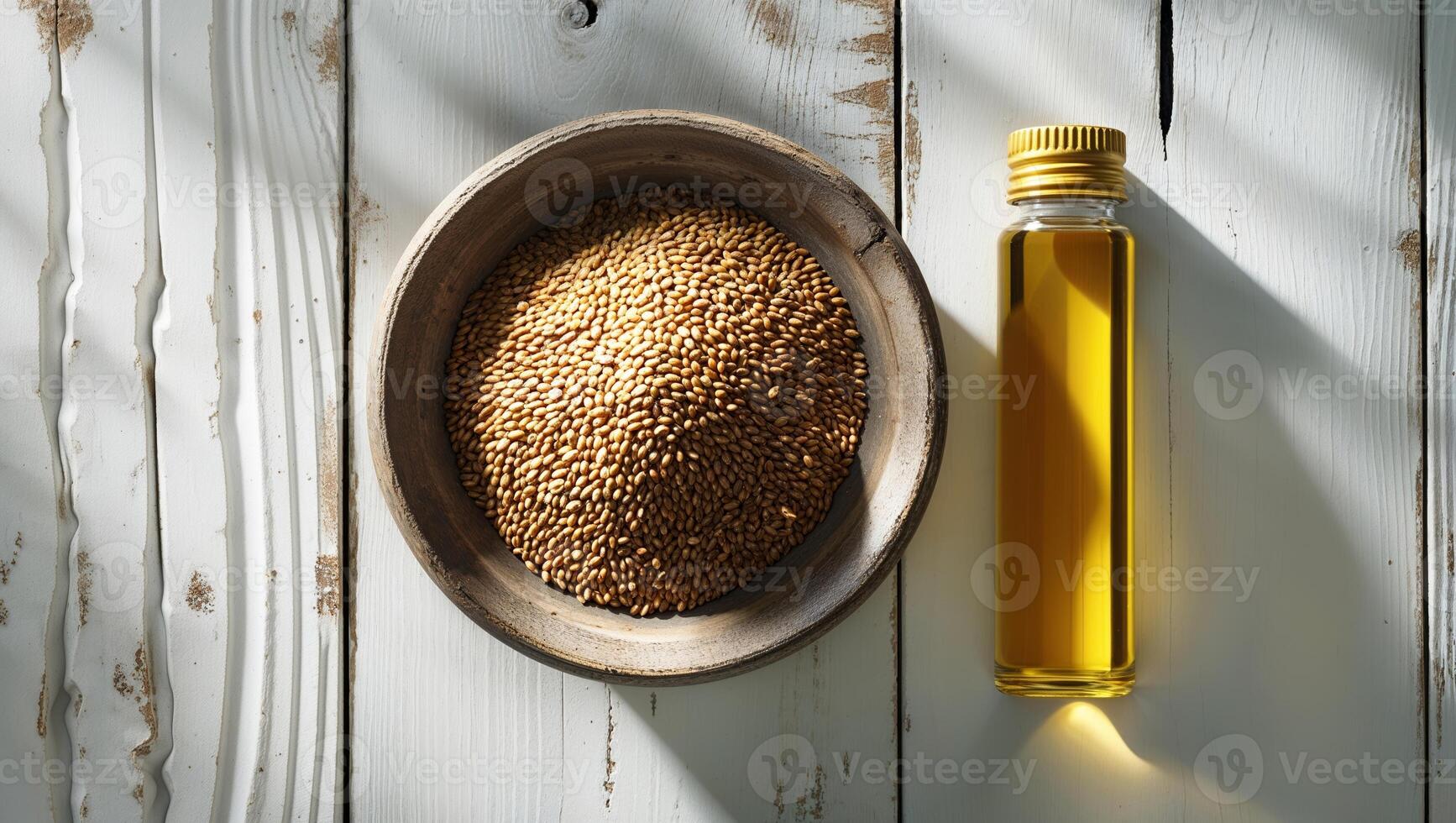 Sesame seeds and oil displayed on a rustic wooden table in natural light photo