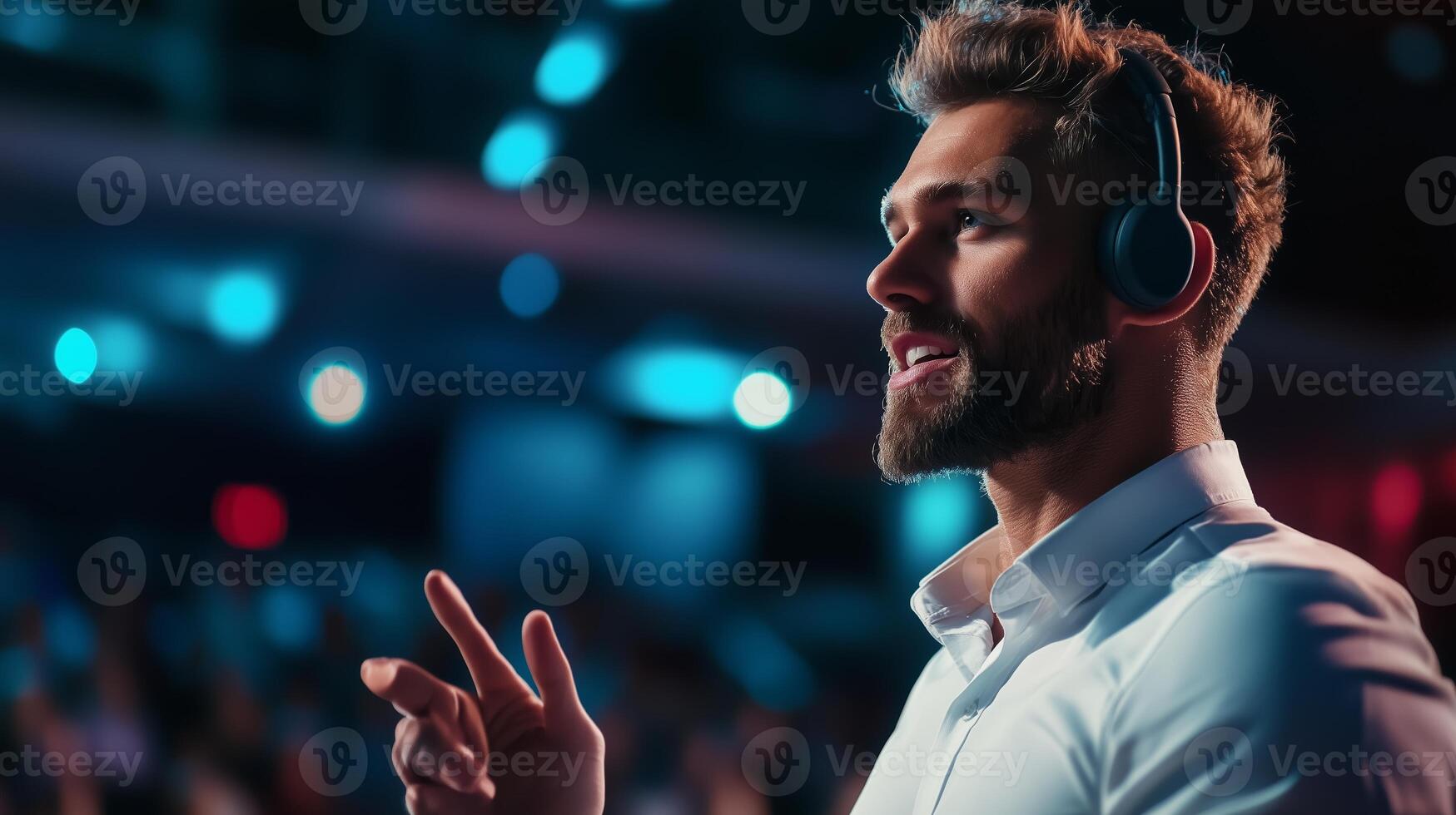 Engaging speaker addressing audience at a conference in a modern venue during evening hours photo
