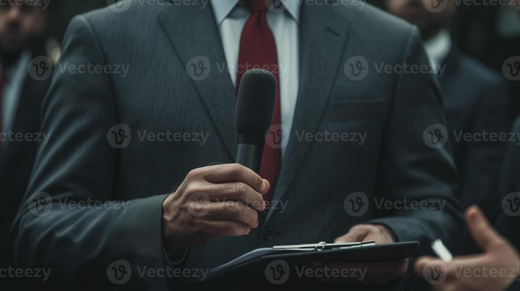 Business professional addresses audience with microphone in formal setting photo