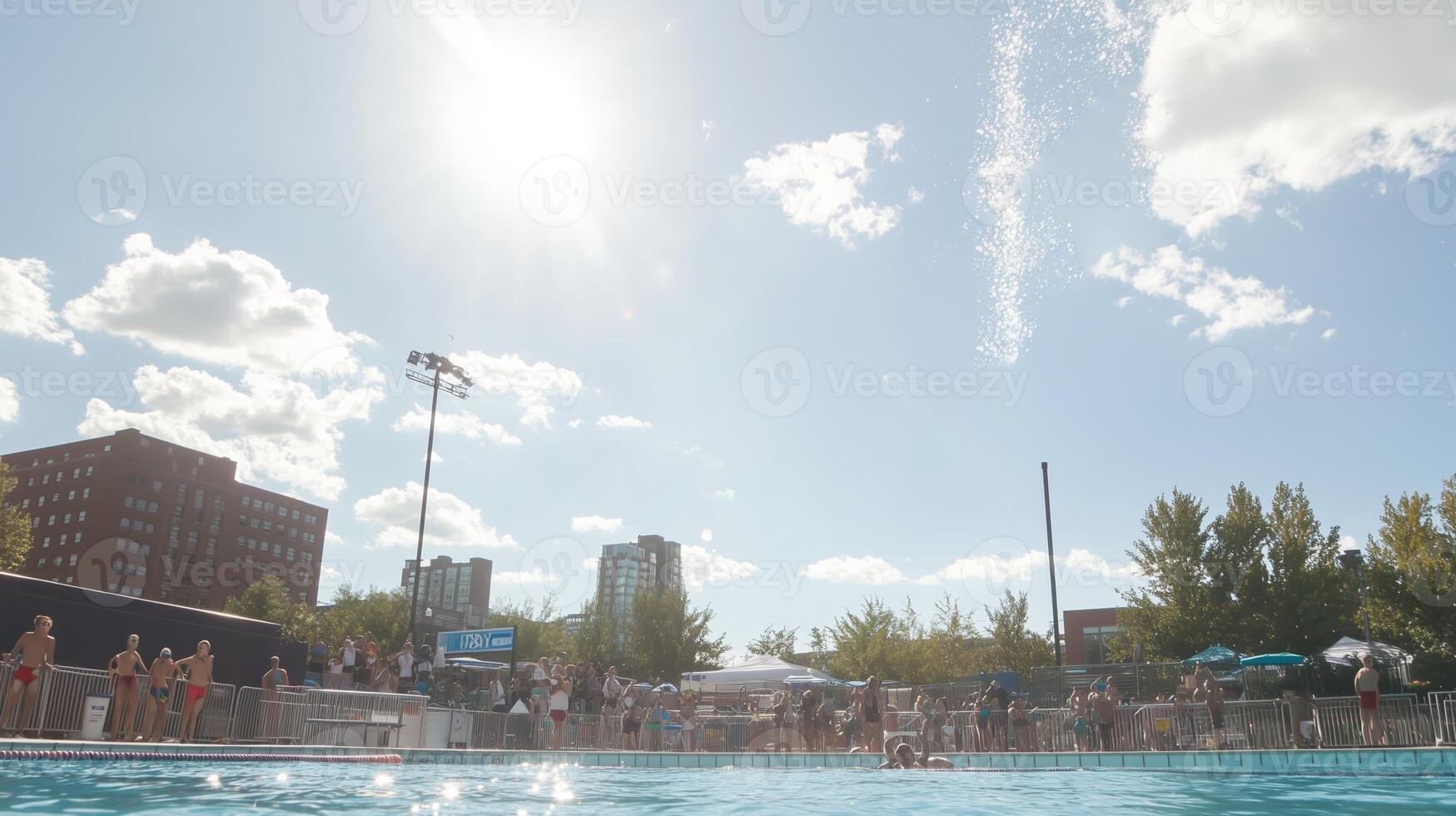 Summer fun at a crowded swimming pool on a sunny day in the city with people enjoying water activities photo
