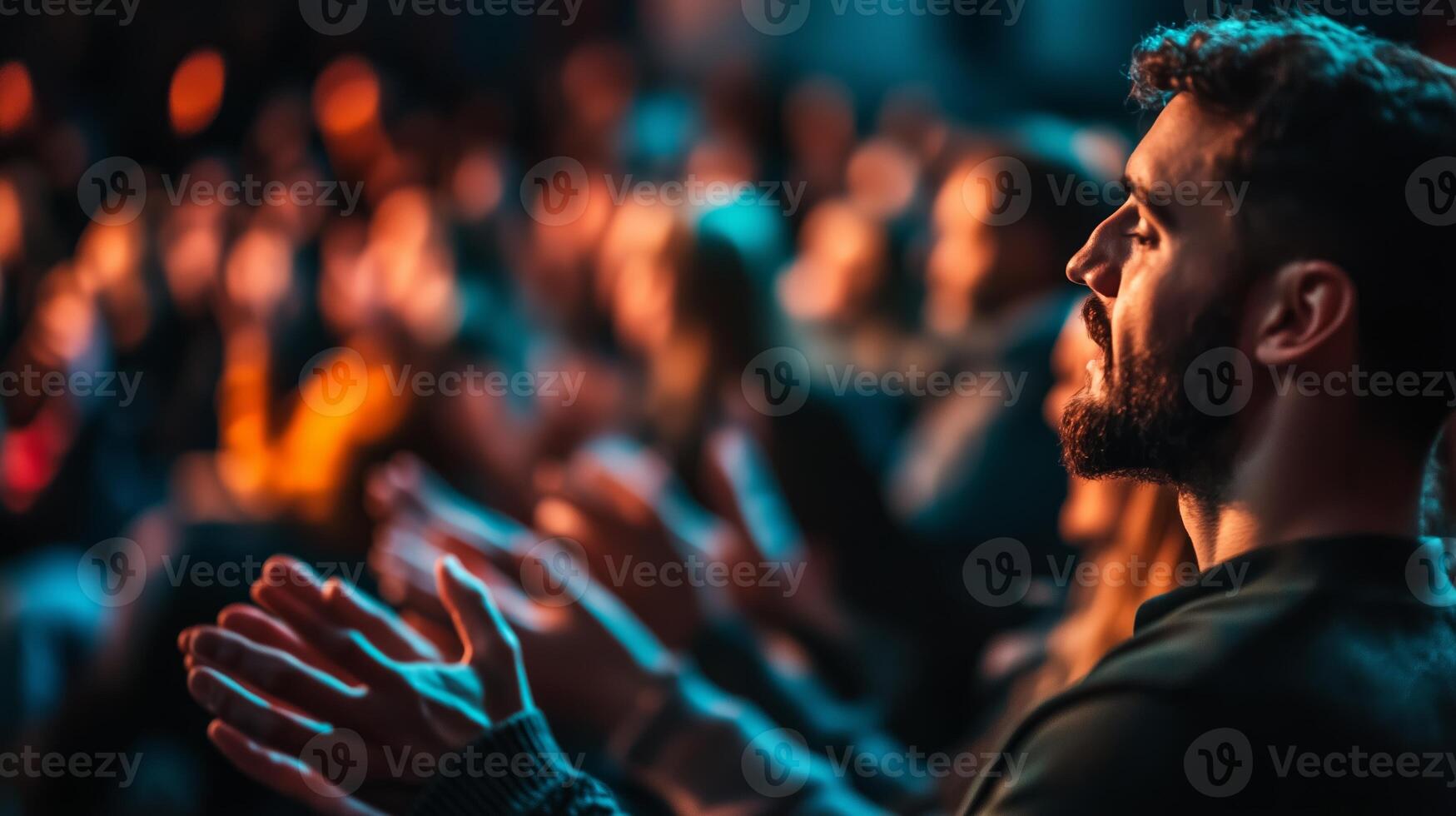 Audience enthusiastically applauding during a live performance in a dimly lit venue photo