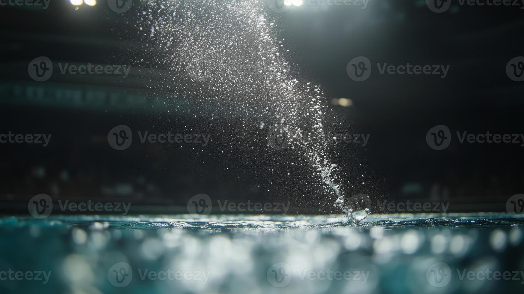 Water splashes dramatically in a sports venue during a competitive swimming event taking place in the evening photo