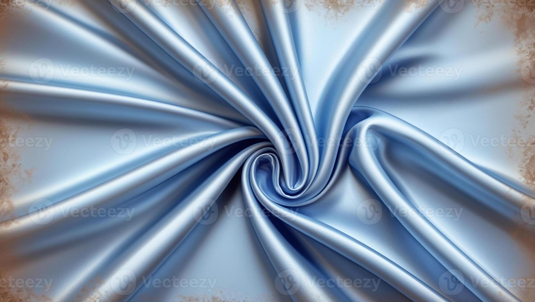 Soft blue satin fabric elegantly arranged in a spiral pattern showcases luxurious texture and sheen in natural light photo