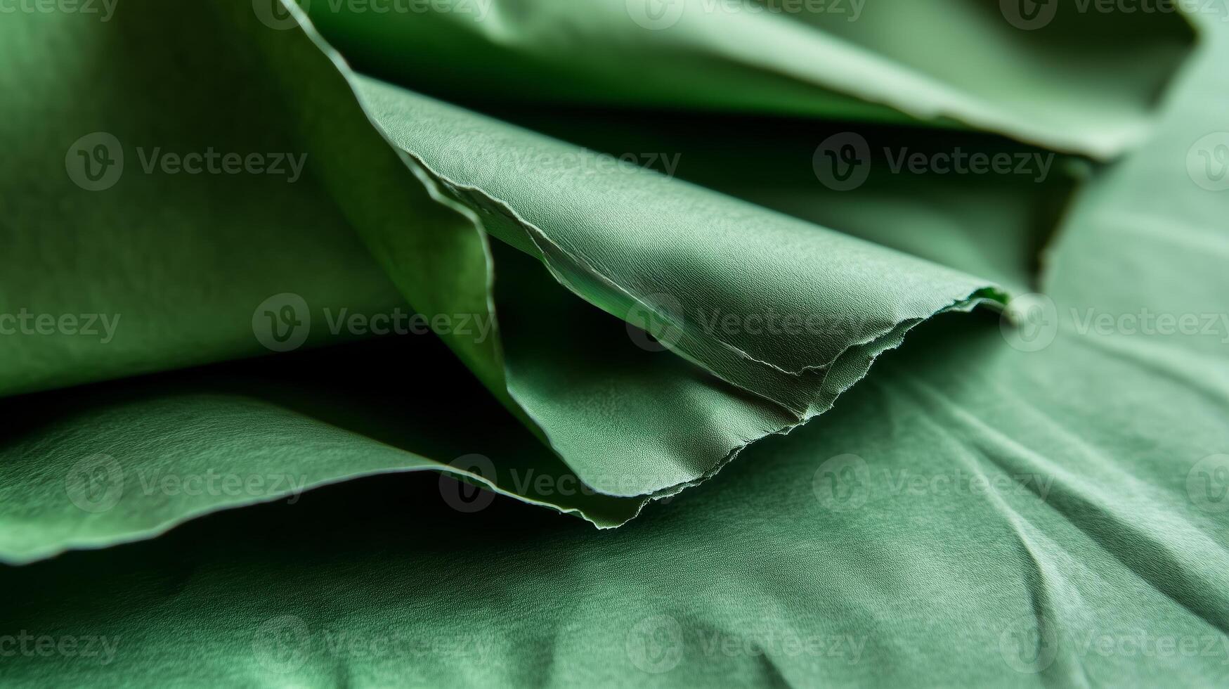 Beautiful green textured paper folded elegantly with soft creases and subtle light reflections during daylight photo