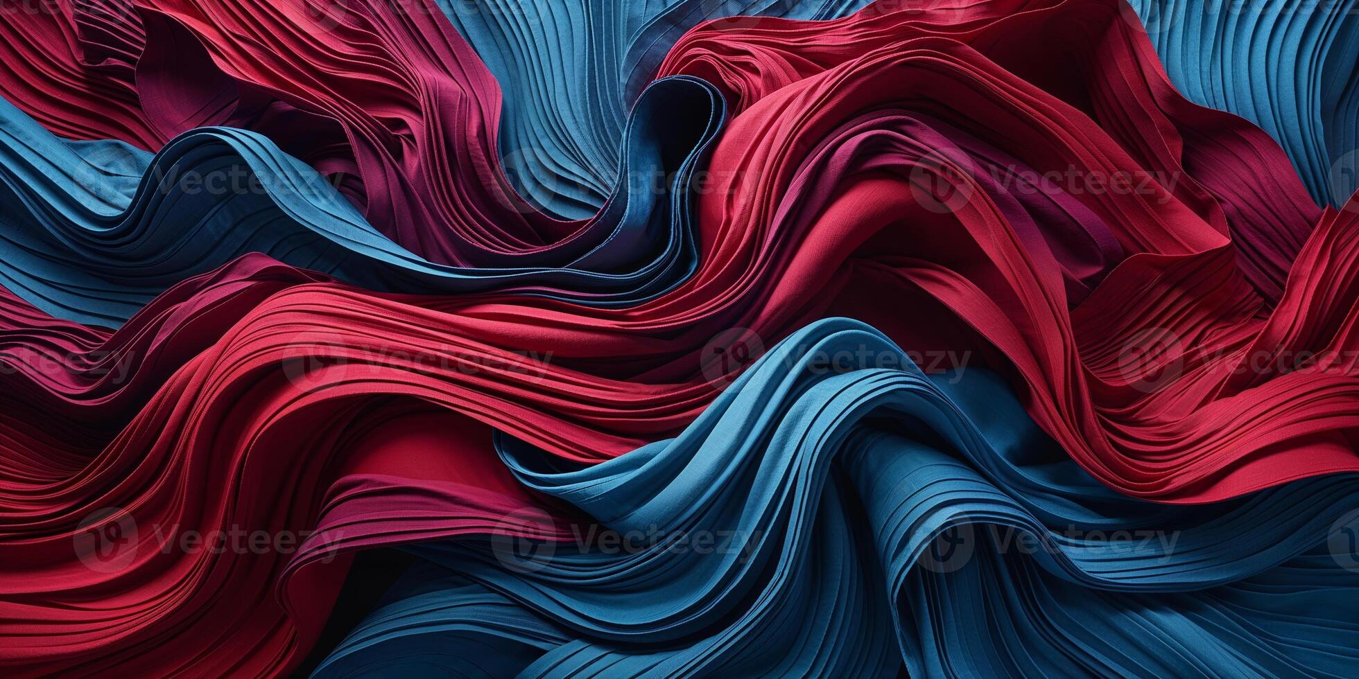 Vibrant folds of fabric create dynamic texture and movement in a rich blend of red and blue colors photo