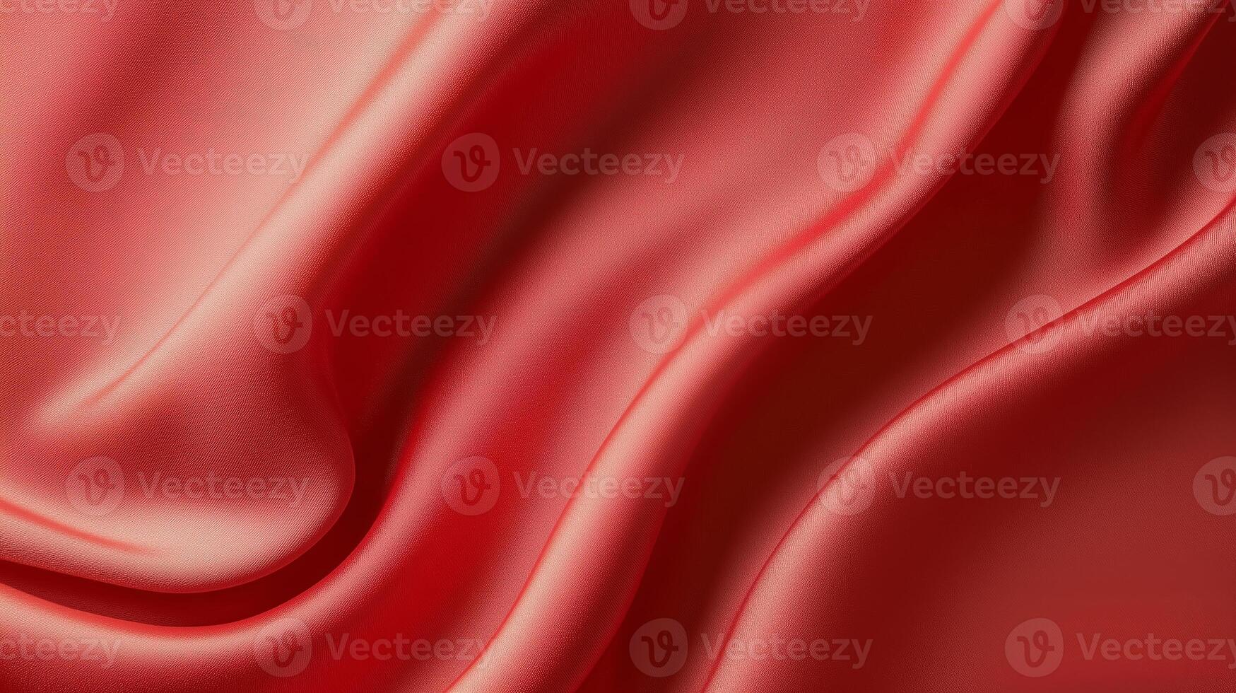 Vibrant red silk fabric drapes elegantly, showcasing its smooth texture and rich color in soft lighting photo