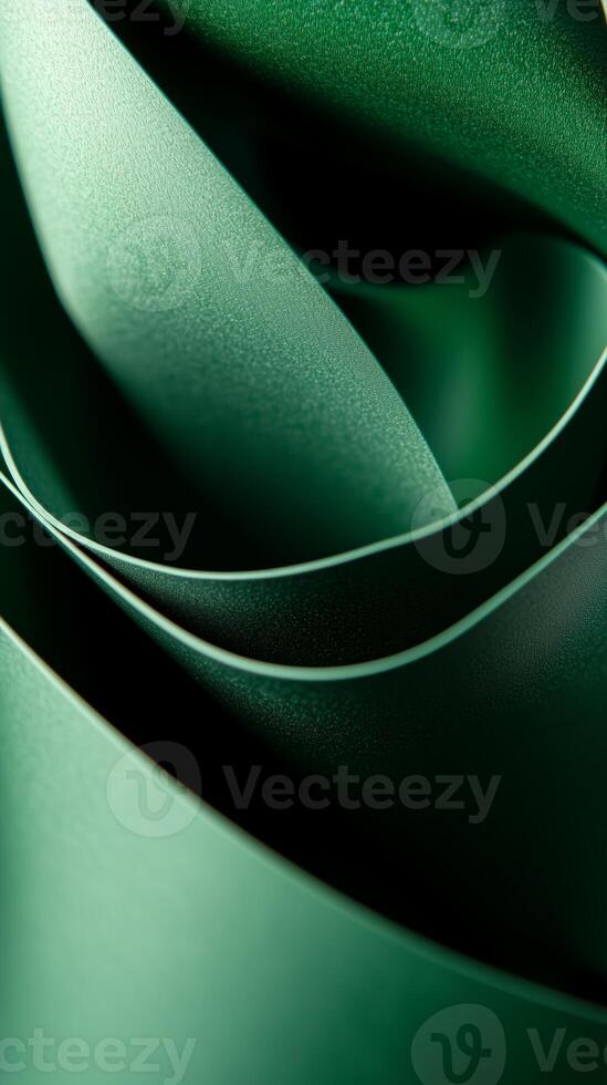 Elegant folds of green fabric create a mesmerizing abstract pattern in soft light photo