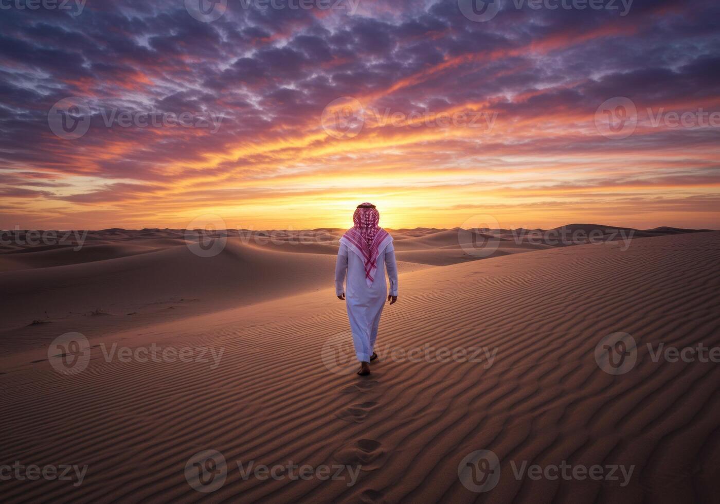 Man Walking in Desert at Sunset with Colorful Sky and Sand Dunes photo
