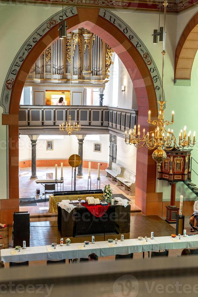 Catholic Church in Germany, altar with flowers, candles and an open bible, confirmation day. photo
