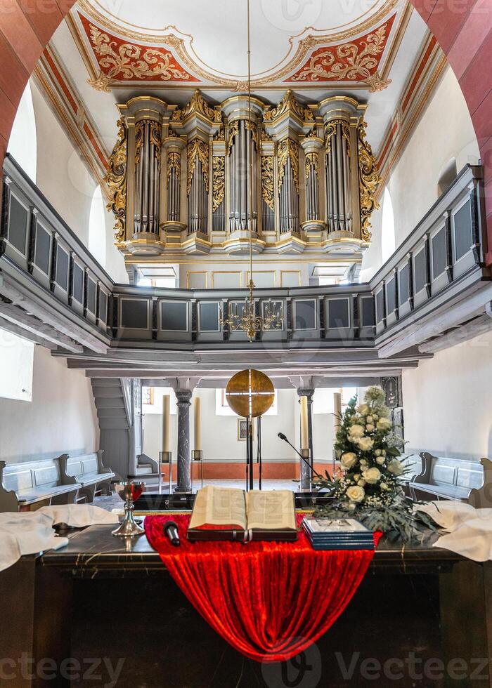 Catholic Church in Germany, altar with flowers, candles and an open bible, confirmation day. photo