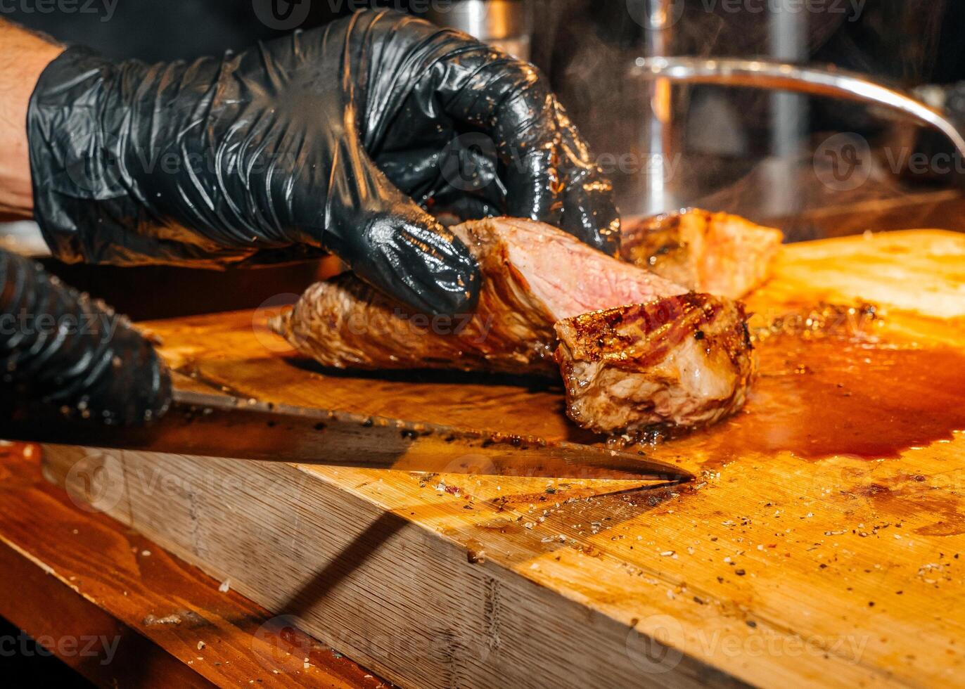 Cutting Midium Steak into Pieces with a Sharp Knife photo