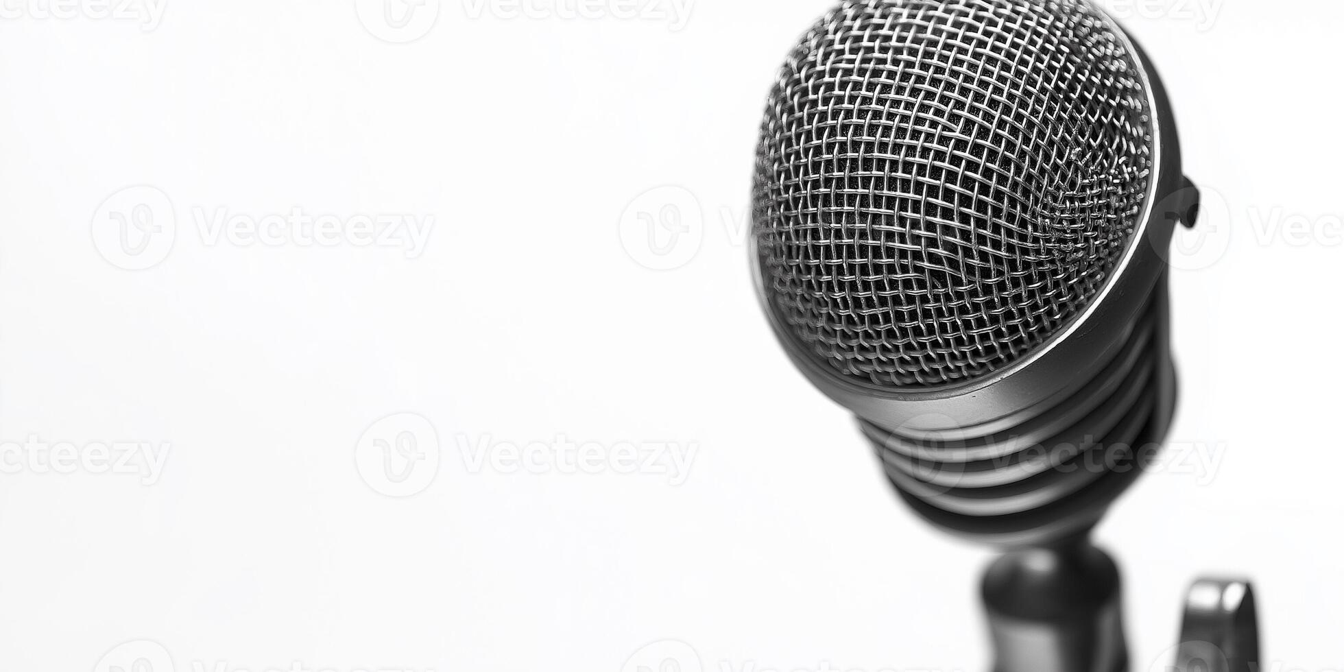 Vintage microphone resting against a white background showcasing its classic design and texture photo