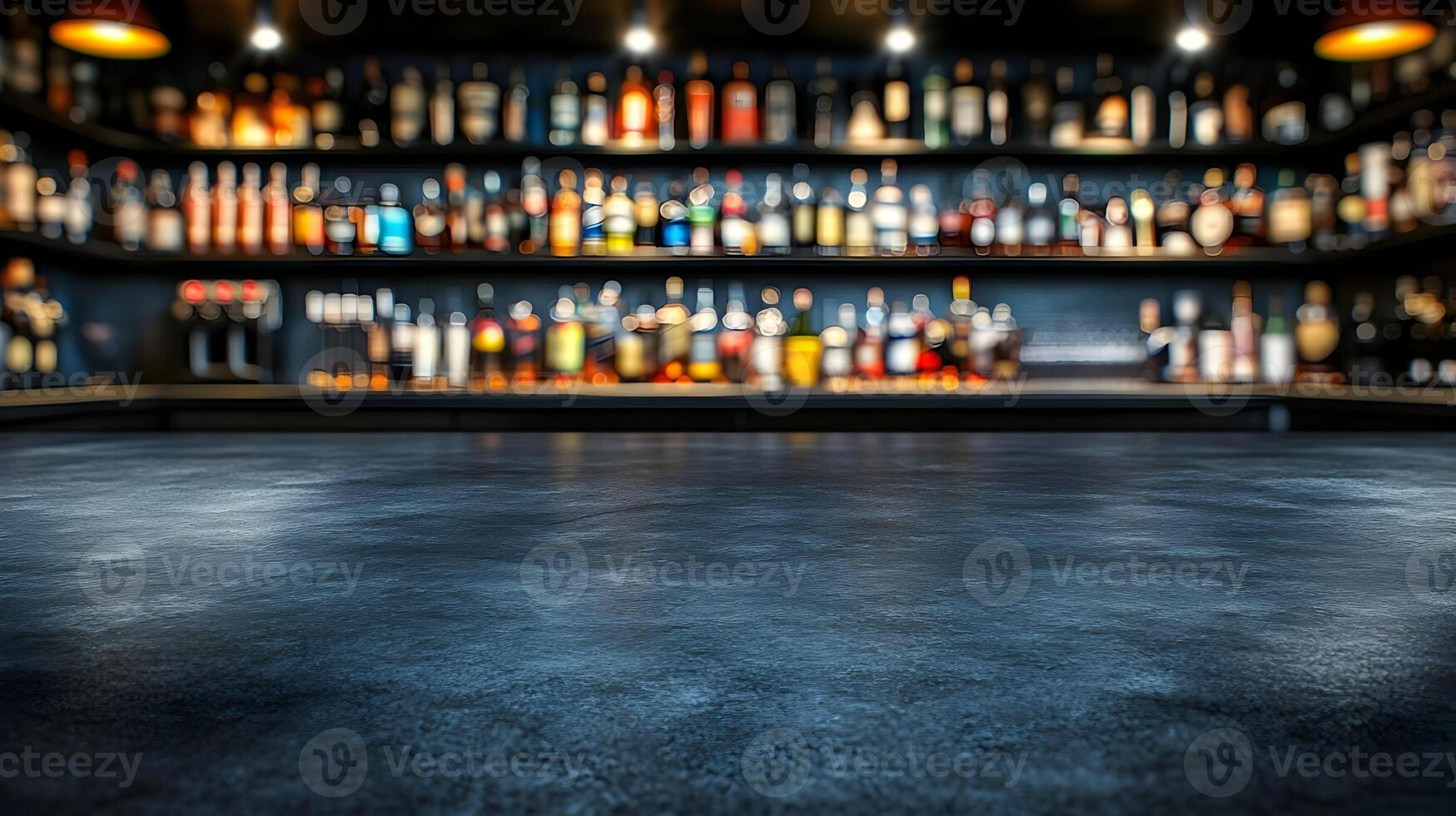 Dark bar counter with blurred liquor bottles. photo