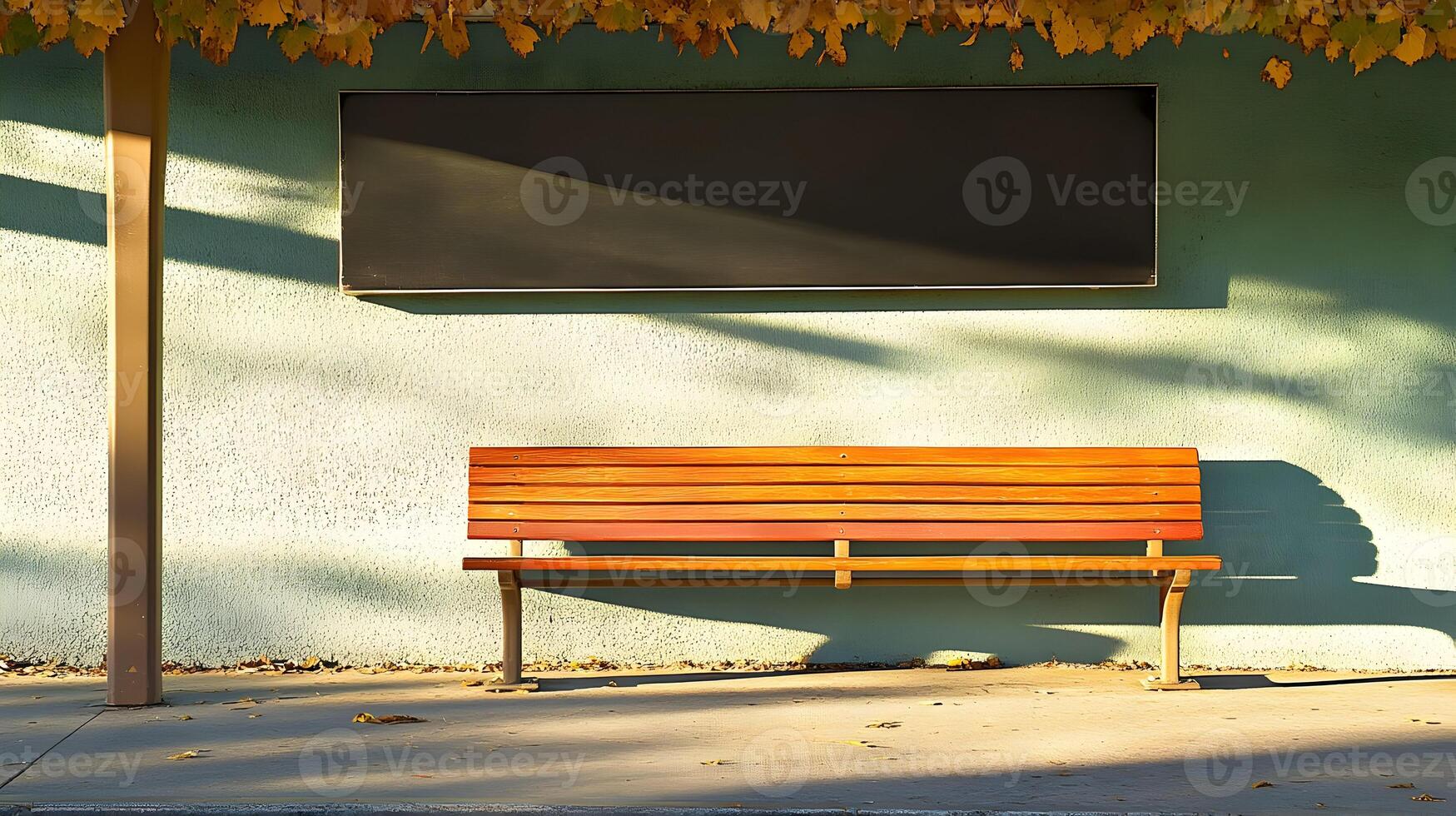 Empty park bench with blank sign under autumn leaves. photo