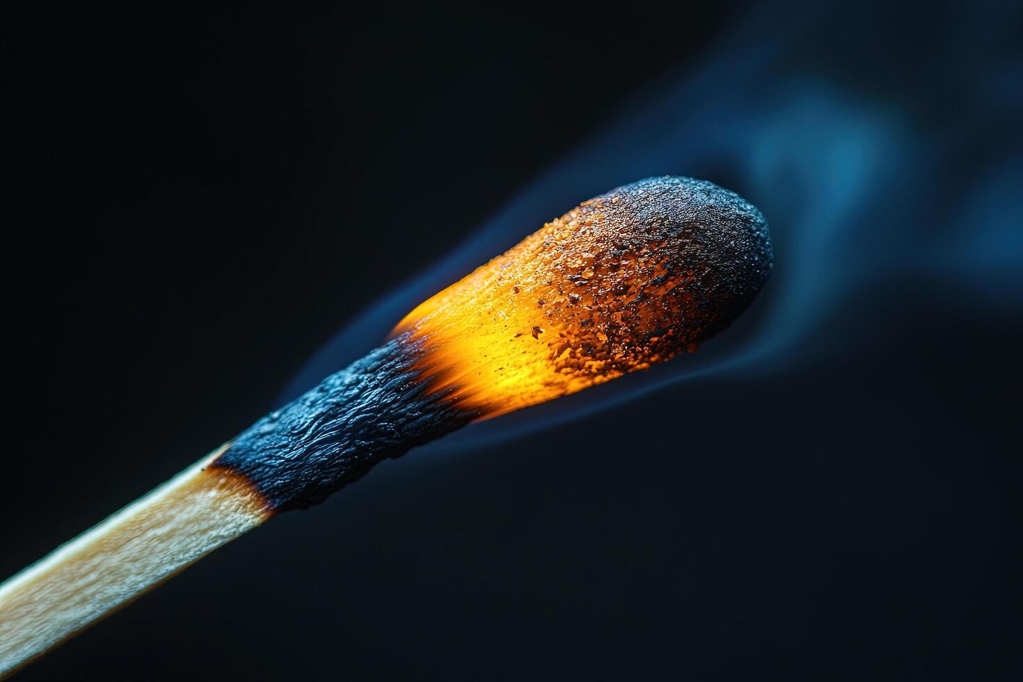 Burning matchstick with smoke on black background. Can be used for fire, danger concepts photo