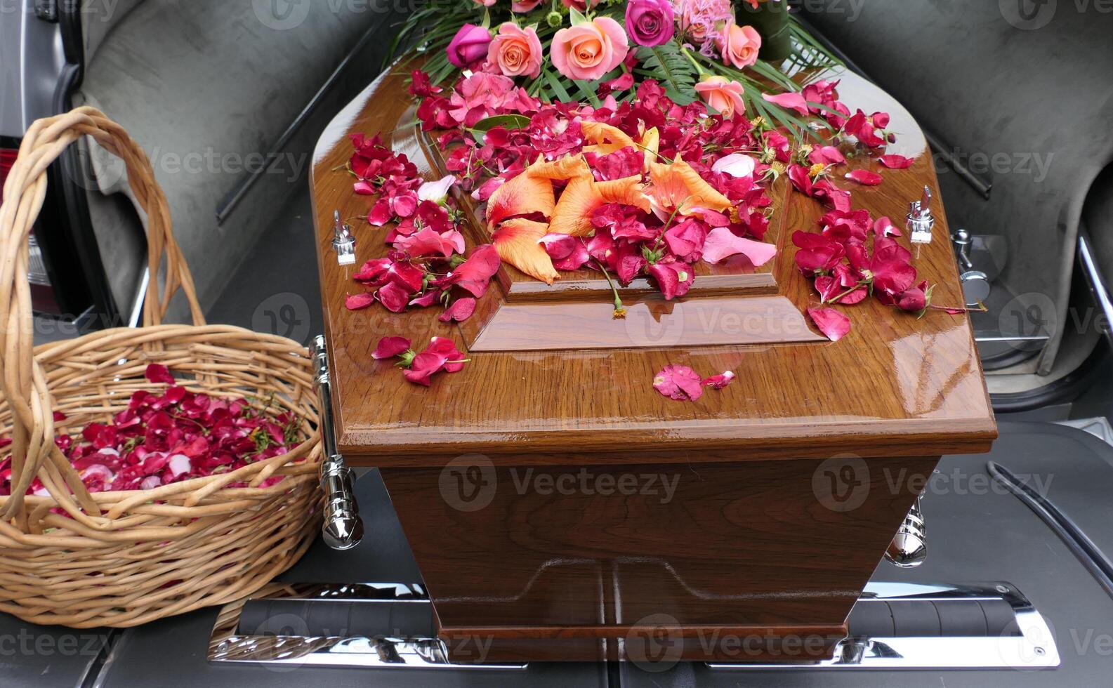 a casket with flowers and a basket photo