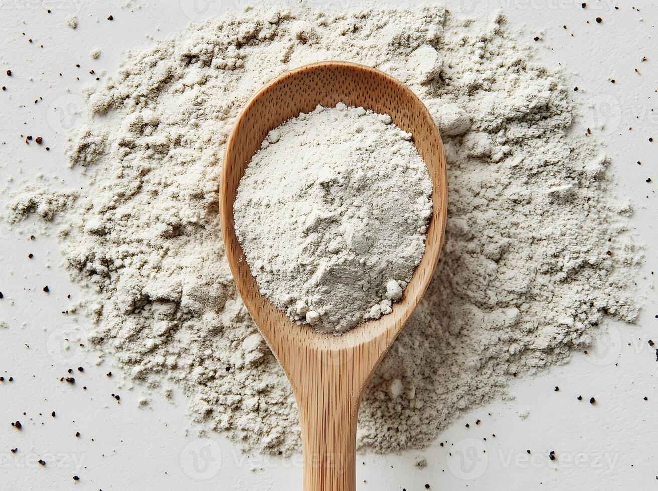 Wooden Spoon Holds Light Gray Powdered Substance photo