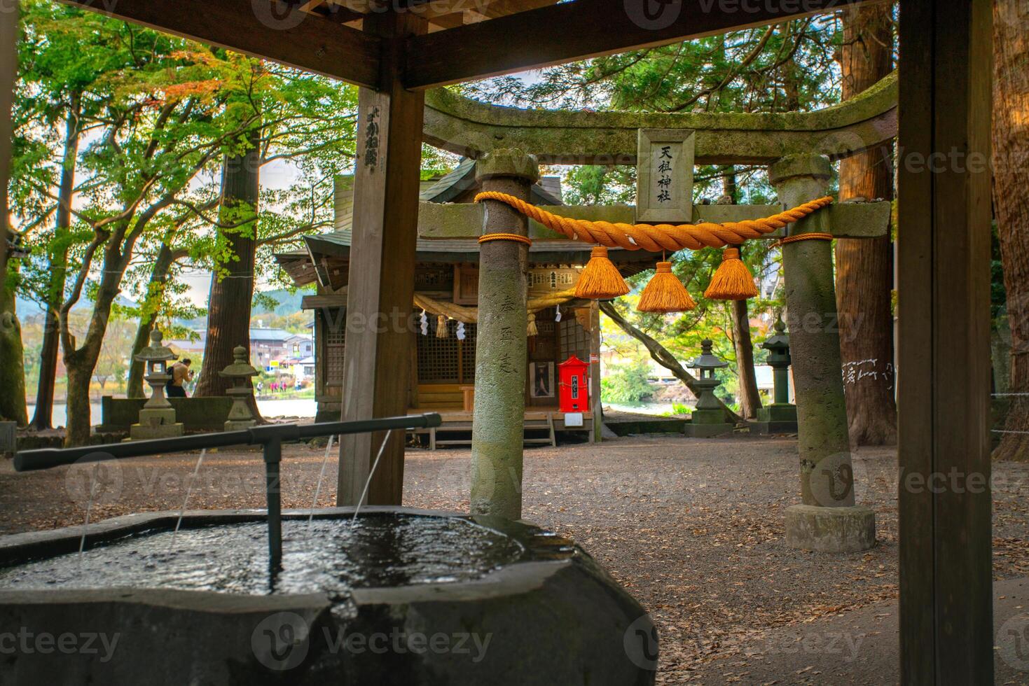Yufuin, Oita, Kyushu, Japan - November 21, 2024 - Scene of Tenso shrine on the bank of Kinrin lake, one of the popular spot to see view of the lake photo