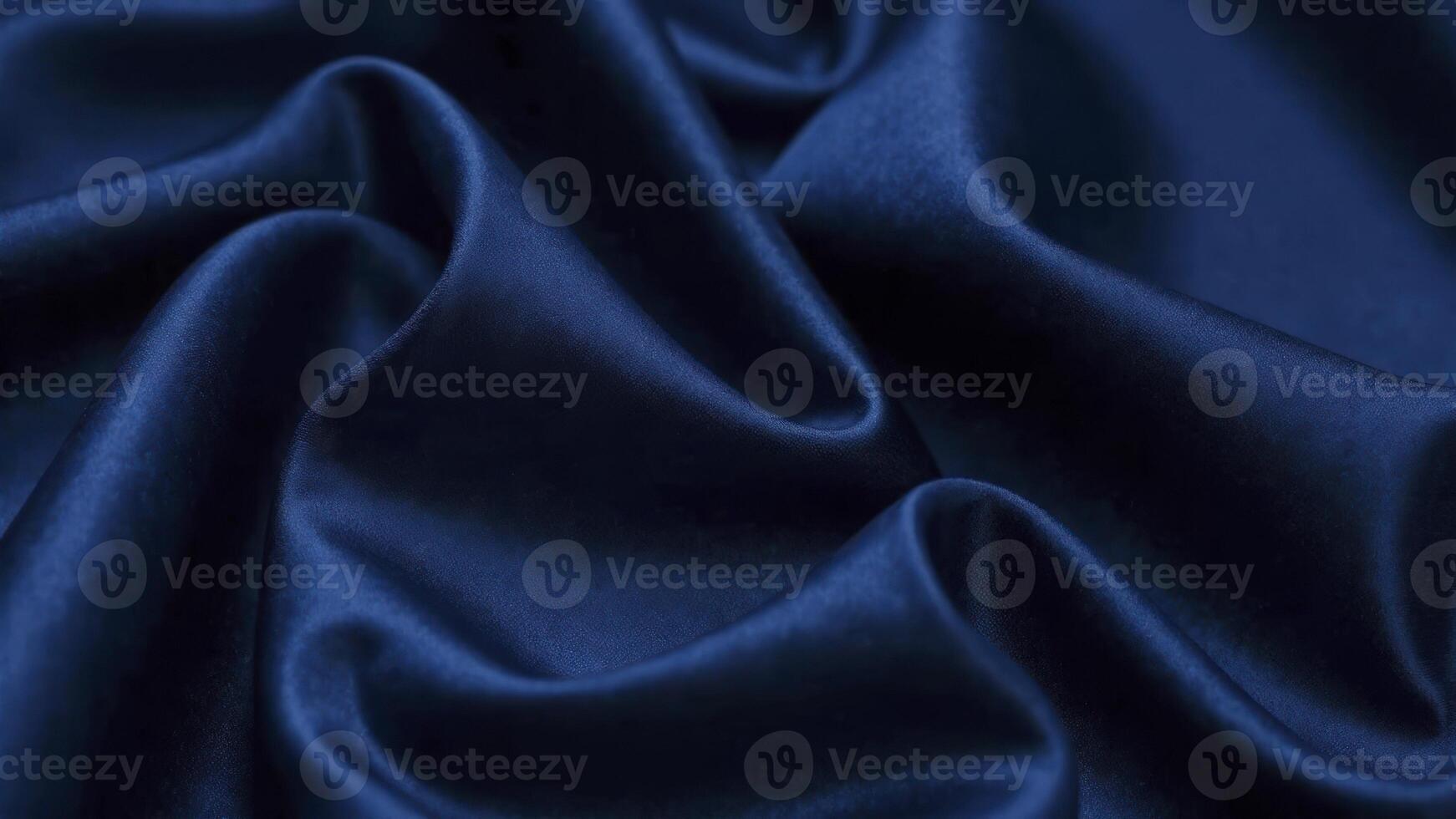 Smooth elegant blue satin fabric forming gentle curves and folds photo