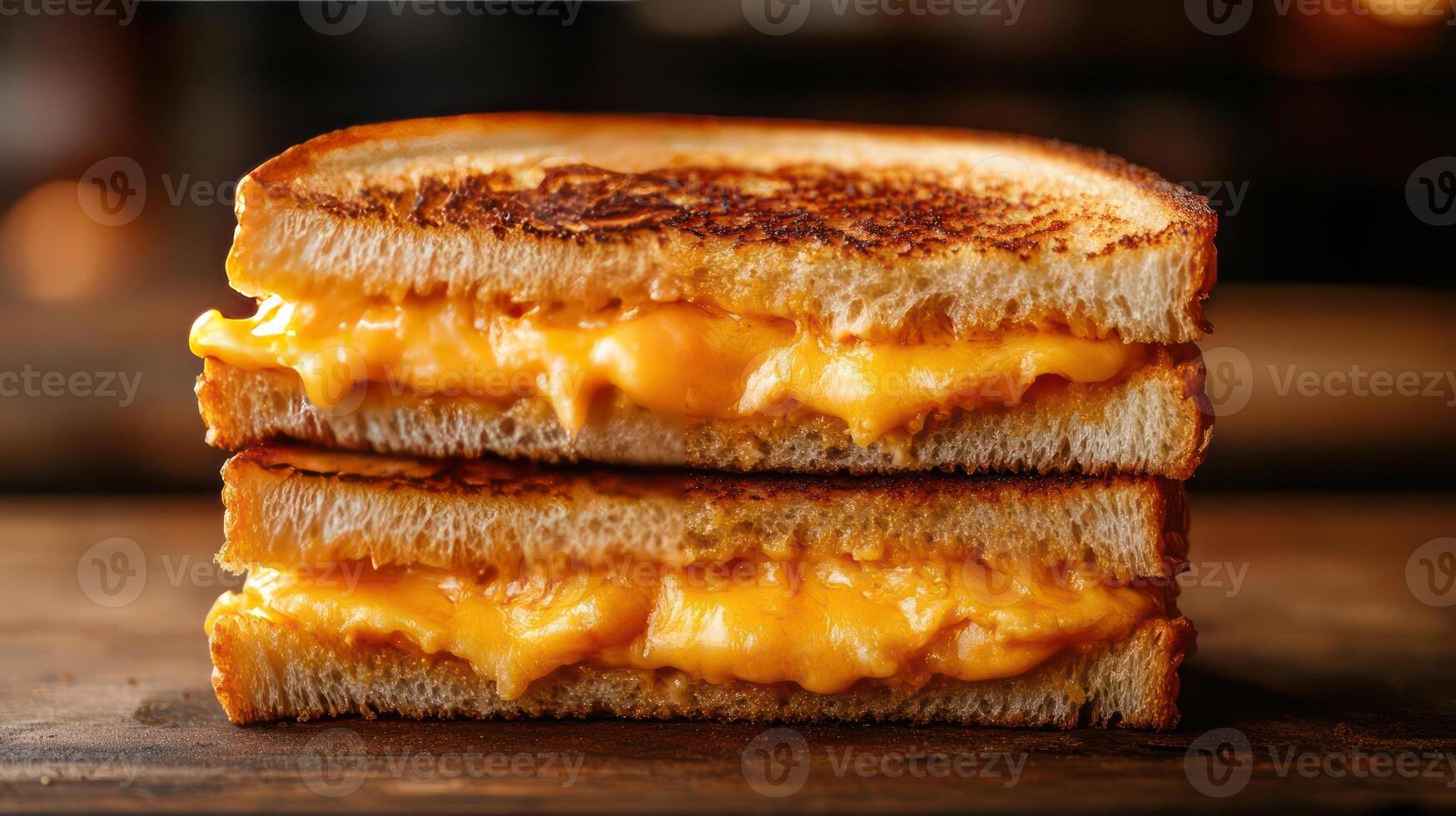 A grilled cheese sandwich with melted cheese between two slices of bread. photo