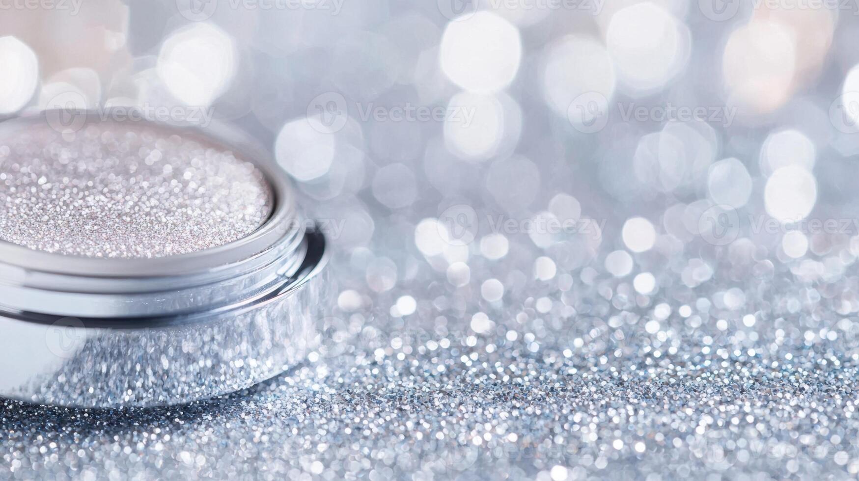 Shimmering eyeshadow cosmetic palette lying against glittery, blurred silver background photo