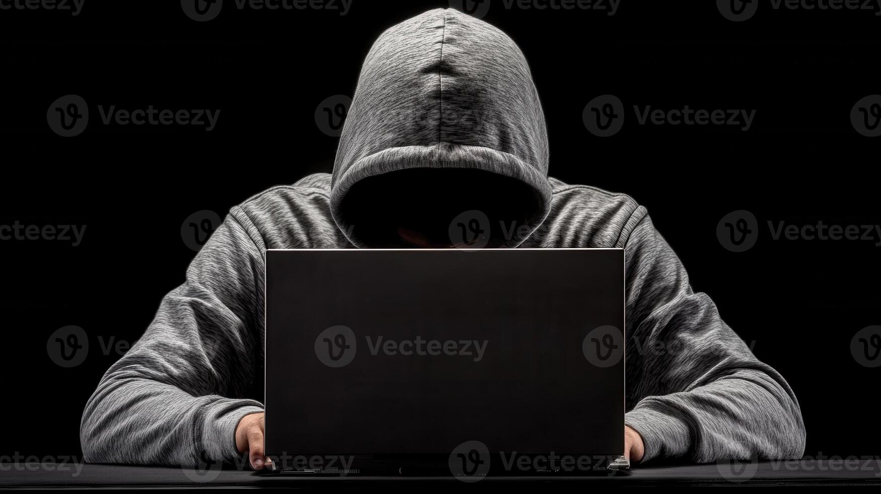 Hooded hacker typing privacy laptop in shadowy workspace, representing cybersecurity threat and digital on breach cyber risk photo