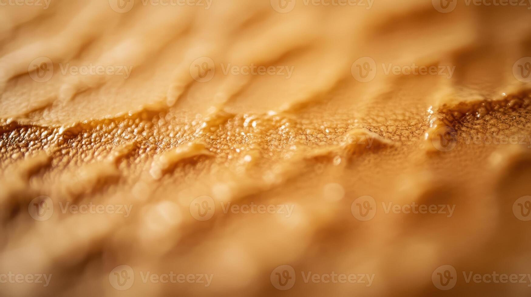 Close-up view of textured surface highlighting intricate patterns and natural features in warm tones under soft lighting photo