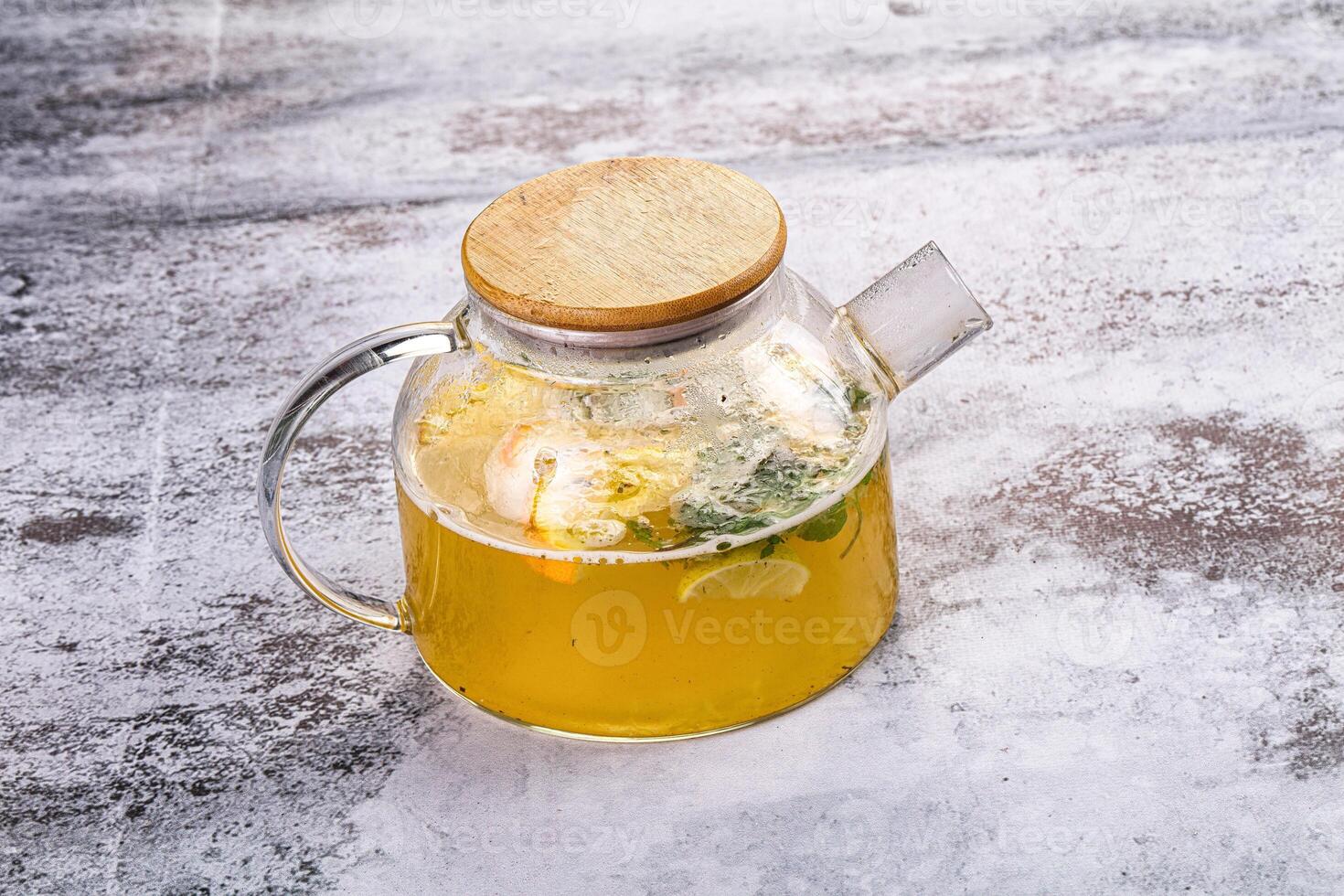 A glass pitcher with a lid filled with lemonade photo