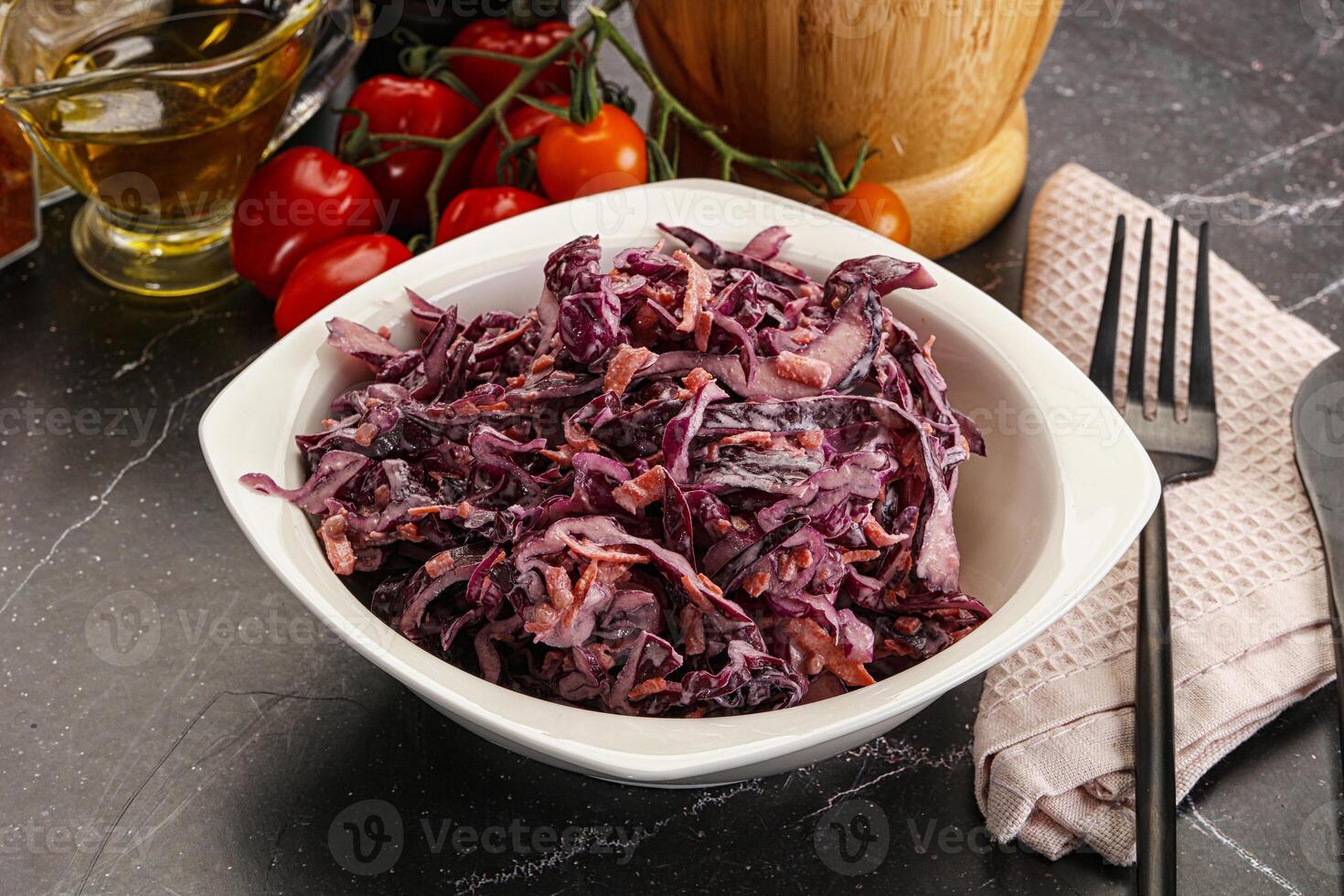 A bowl of red cabbage with a knife and fork photo