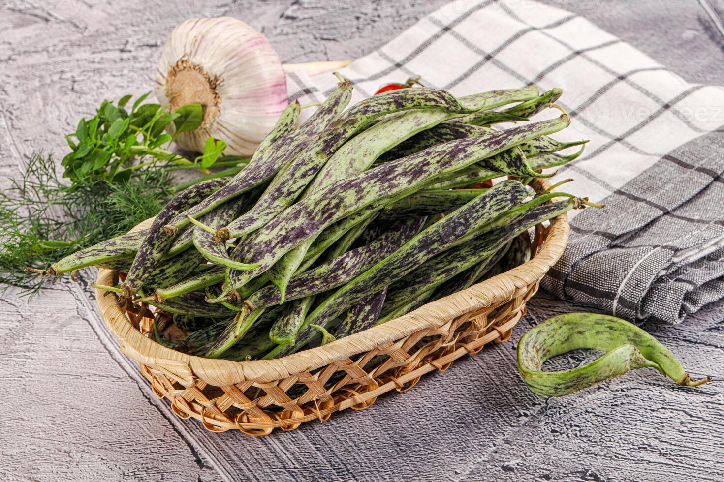 A basket filled with green beans and garlic photo